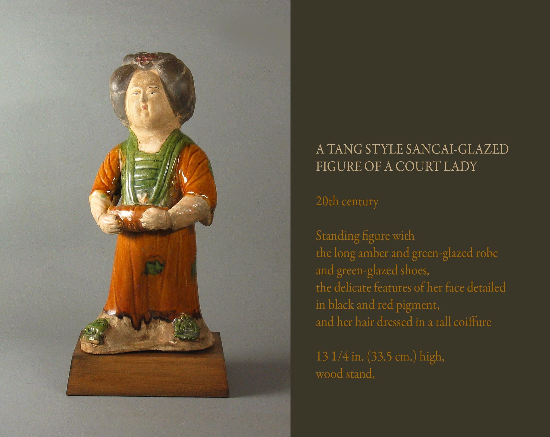 A Tang style Sancai-glazed
Figure of a Court Lady,

20th century.

Standing figure with 
the long amber and green-glazed robe 
and green-glazed shoes, 
the delicate features of her face detailed 
in black and red pigment, 
and her hair