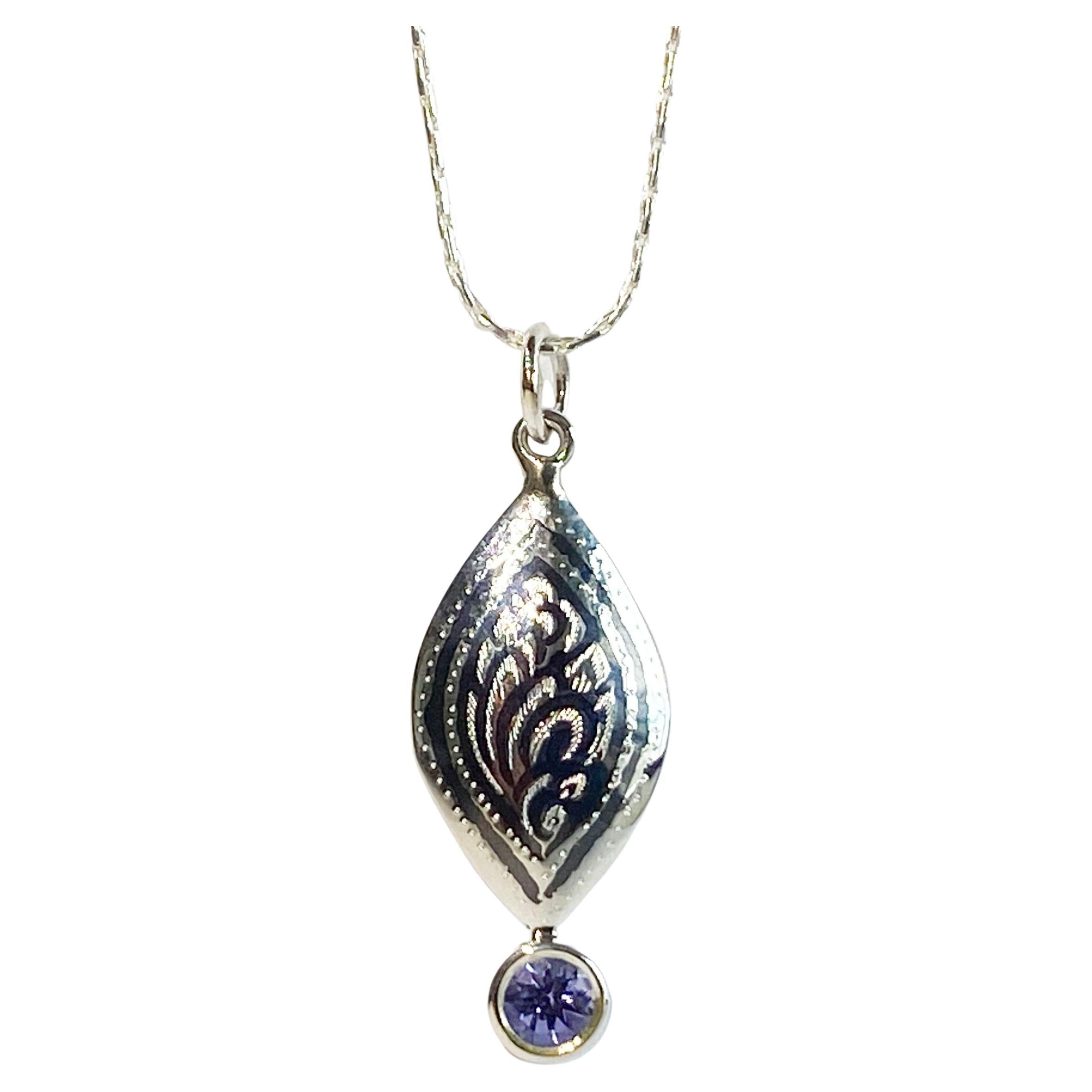 A Silver Filagree Pendant set with a 5MM Round Tanzanite  For Sale