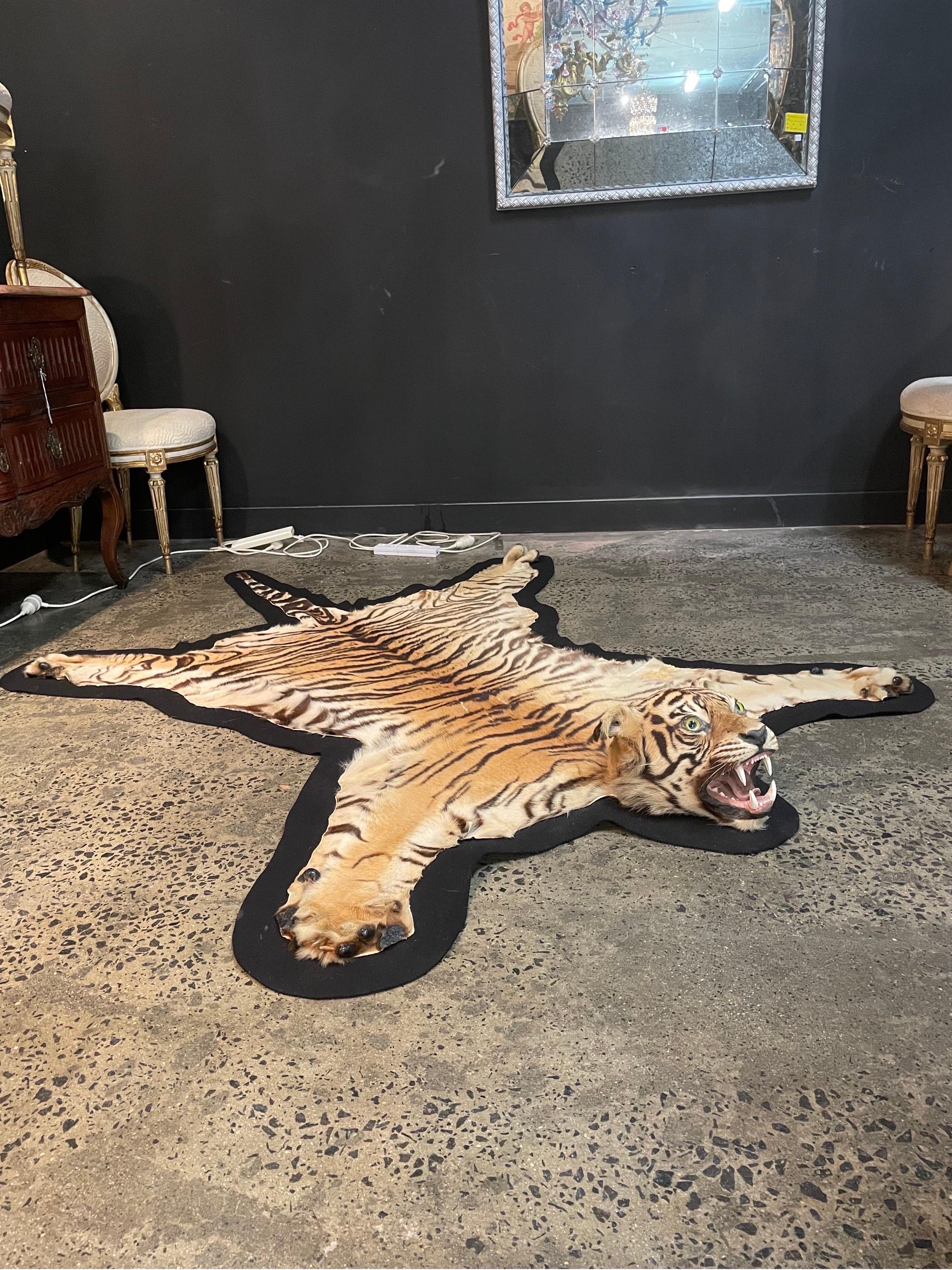 A Taxidermied Tiger Skin Rug, 1960s

Mounted on black felt, with glass eyes.

Dimension: Length: 215 cm Width: 165 cm Height: 19 cm.

Provenance: Private Australian Collector Acquired in 1960s.

Notes: This piece is sold with an accompanying letter