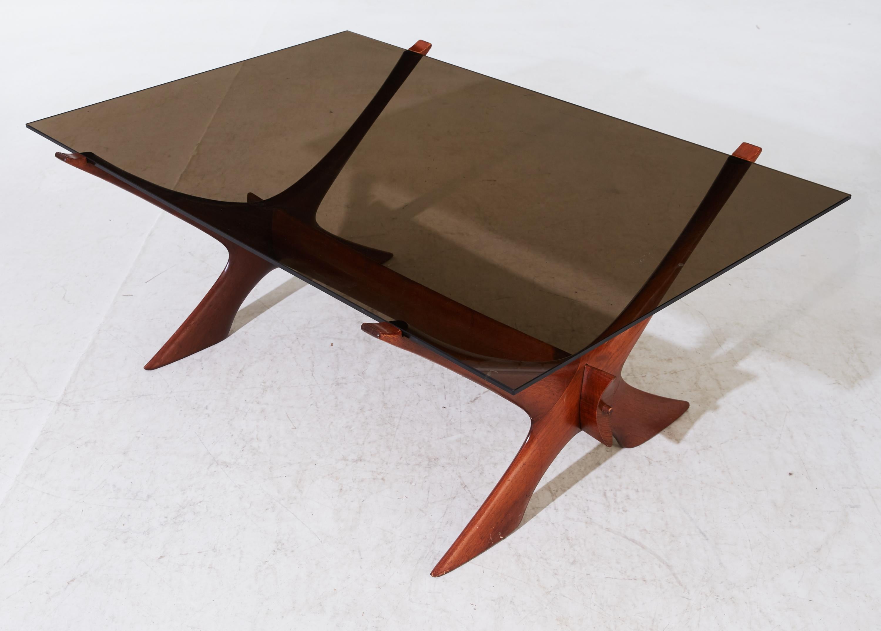 The large smoked glass top on two X-shape solid teak supports. This model named 
