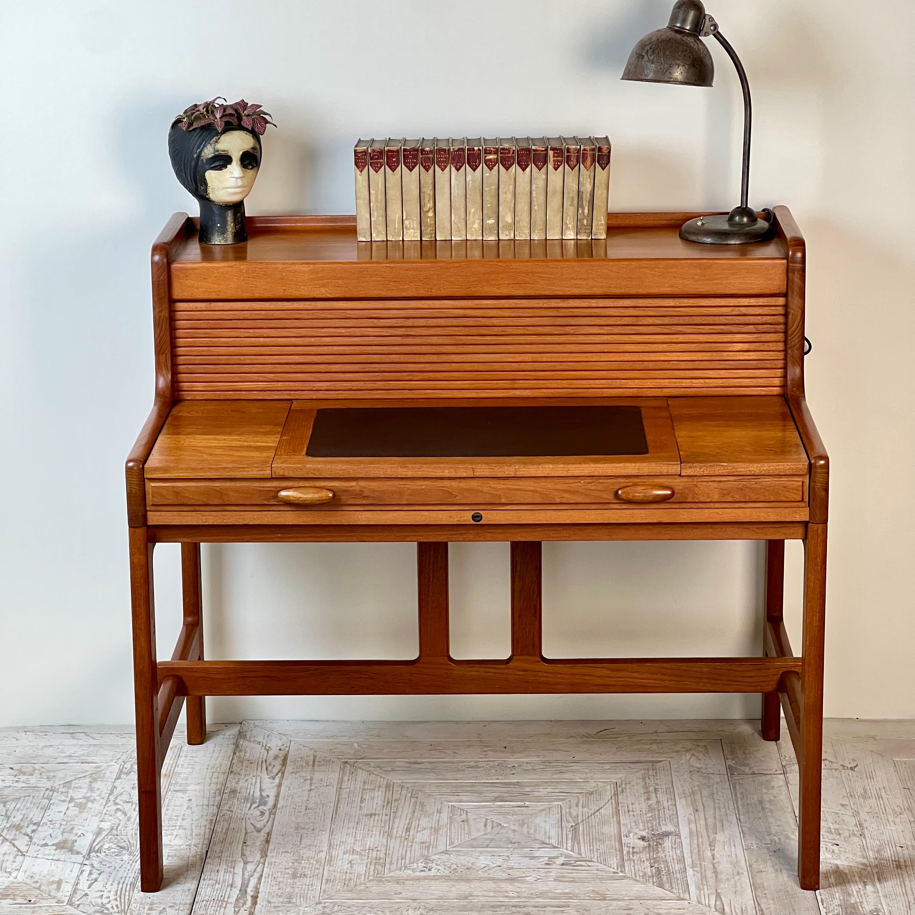 A Teak Tambour Desk designed by John Mortensen for Dyrlund, Denmark.

This innovative and ergonomically designed teak desk was created by John Mortensen for Dyrlund in Denmark. As is typical with this cabinet maker, the craftsmanship is exceptional