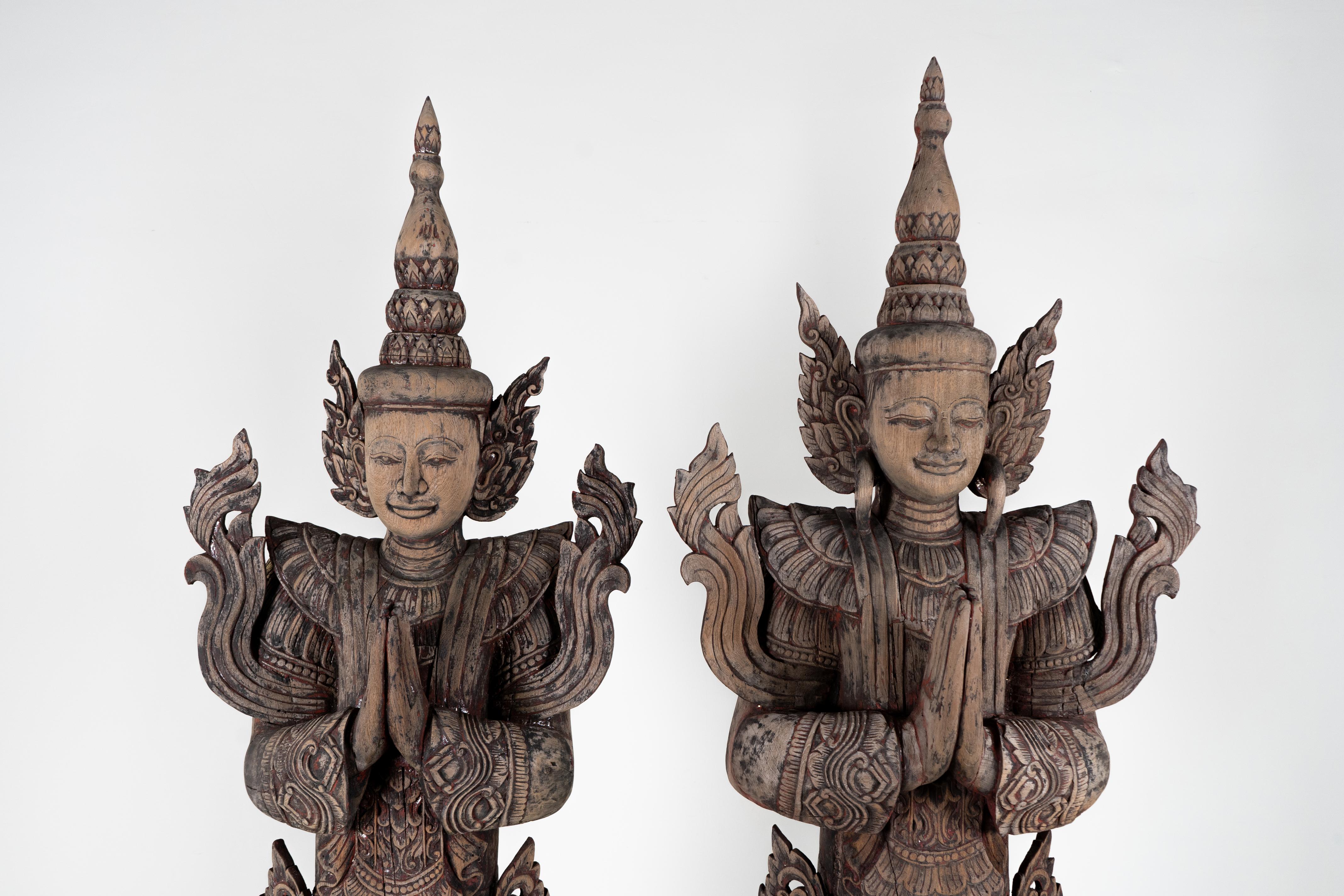 Thai temples often featured various kinds of carved figures including Buddhas and angels. This large set of wooden greeting angels is based on the sculptures that typically flanked altars or entrances. Thai Buddhists, like members of other faiths,