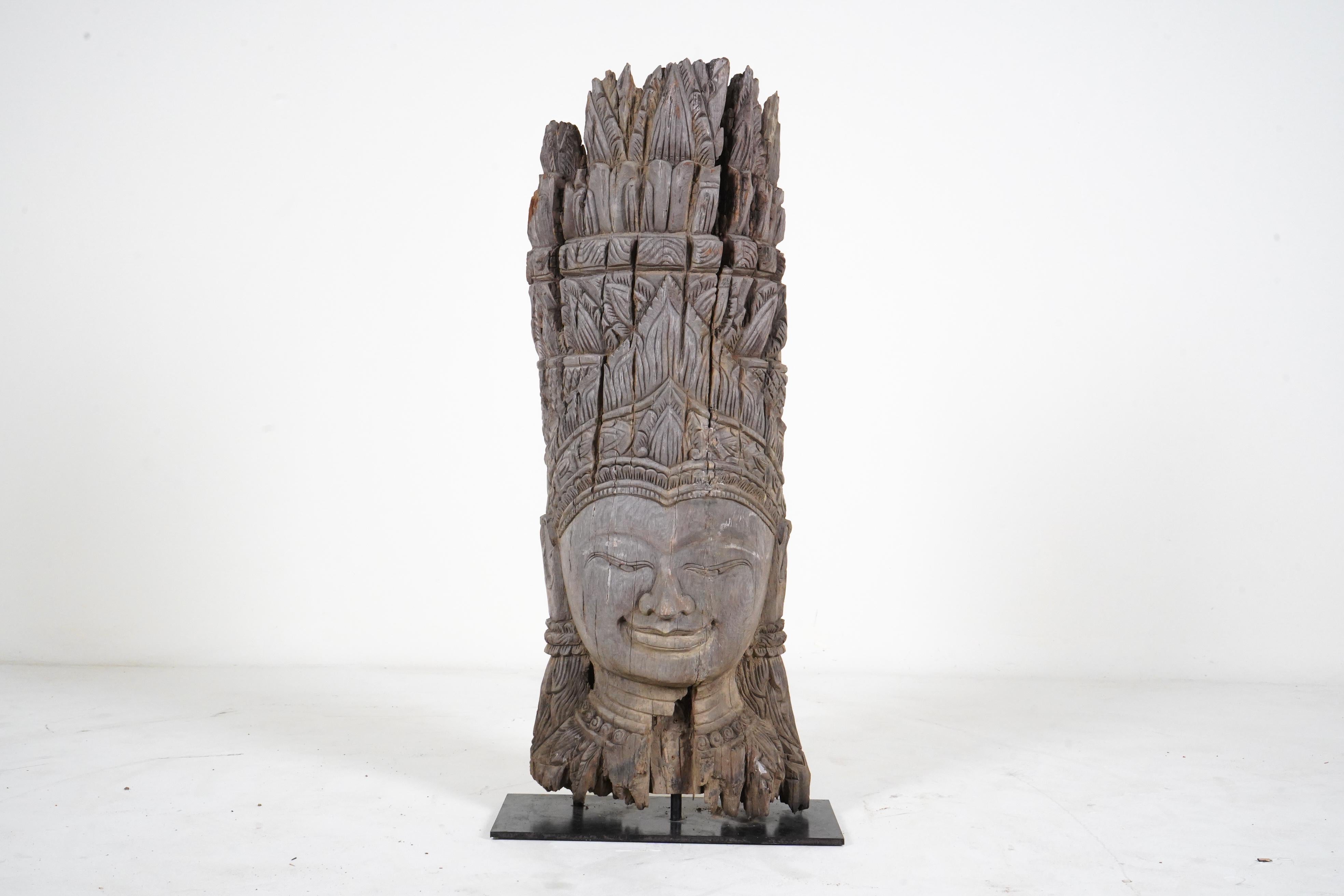 Newly carved from reclaimed teak, this large bust takes the form of an apsara. With origins in both Hindu and Buddhist mythology, Apsaras are female spirits of the clouds and waters. They are also referred to as 