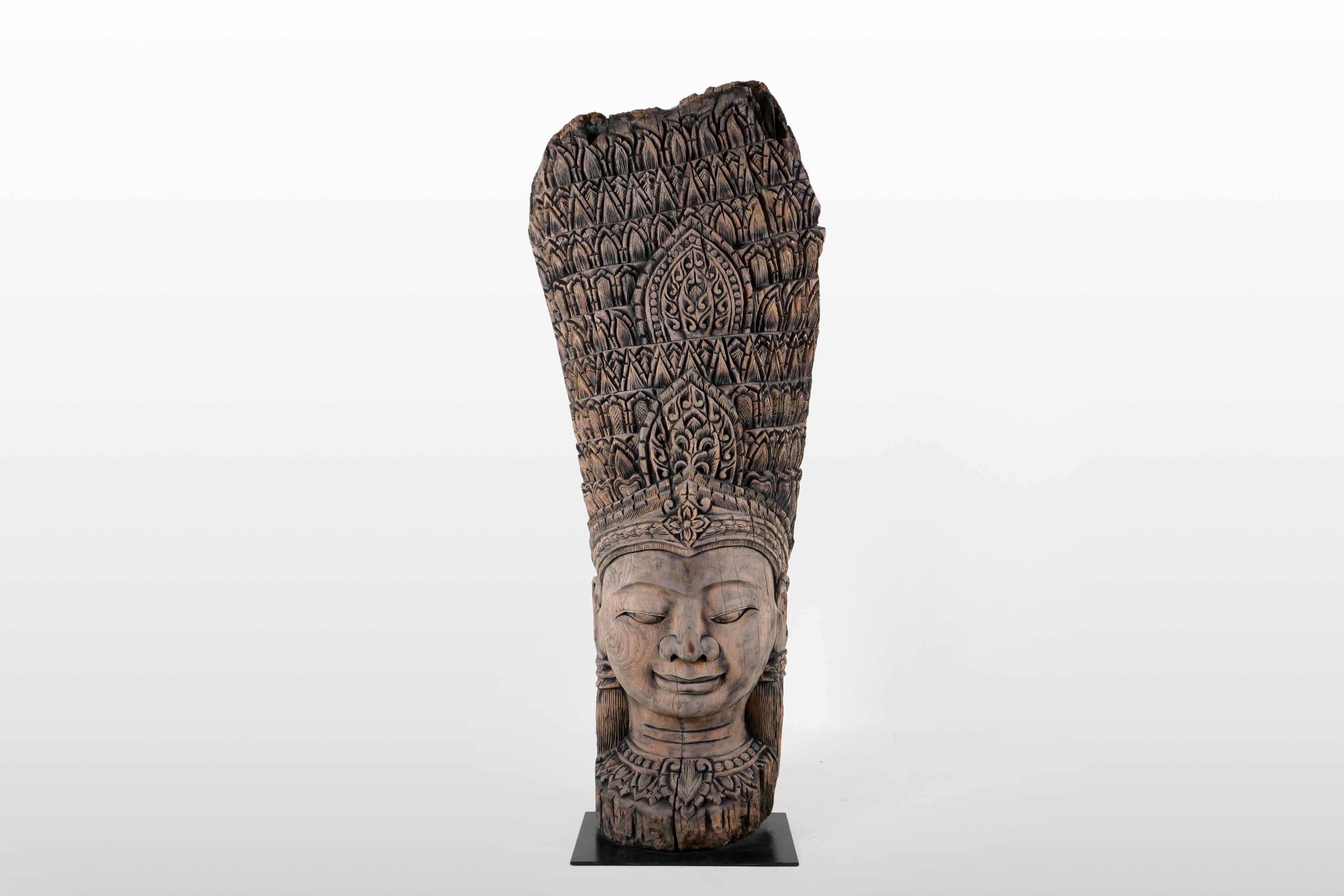 Newly carved from reclaimed teakwood, this bust takes the form of an apsara. With origins in both Hindu and Buddhist mythology, Apsaras are female spirits of the clouds and waters. They are also referred to as 