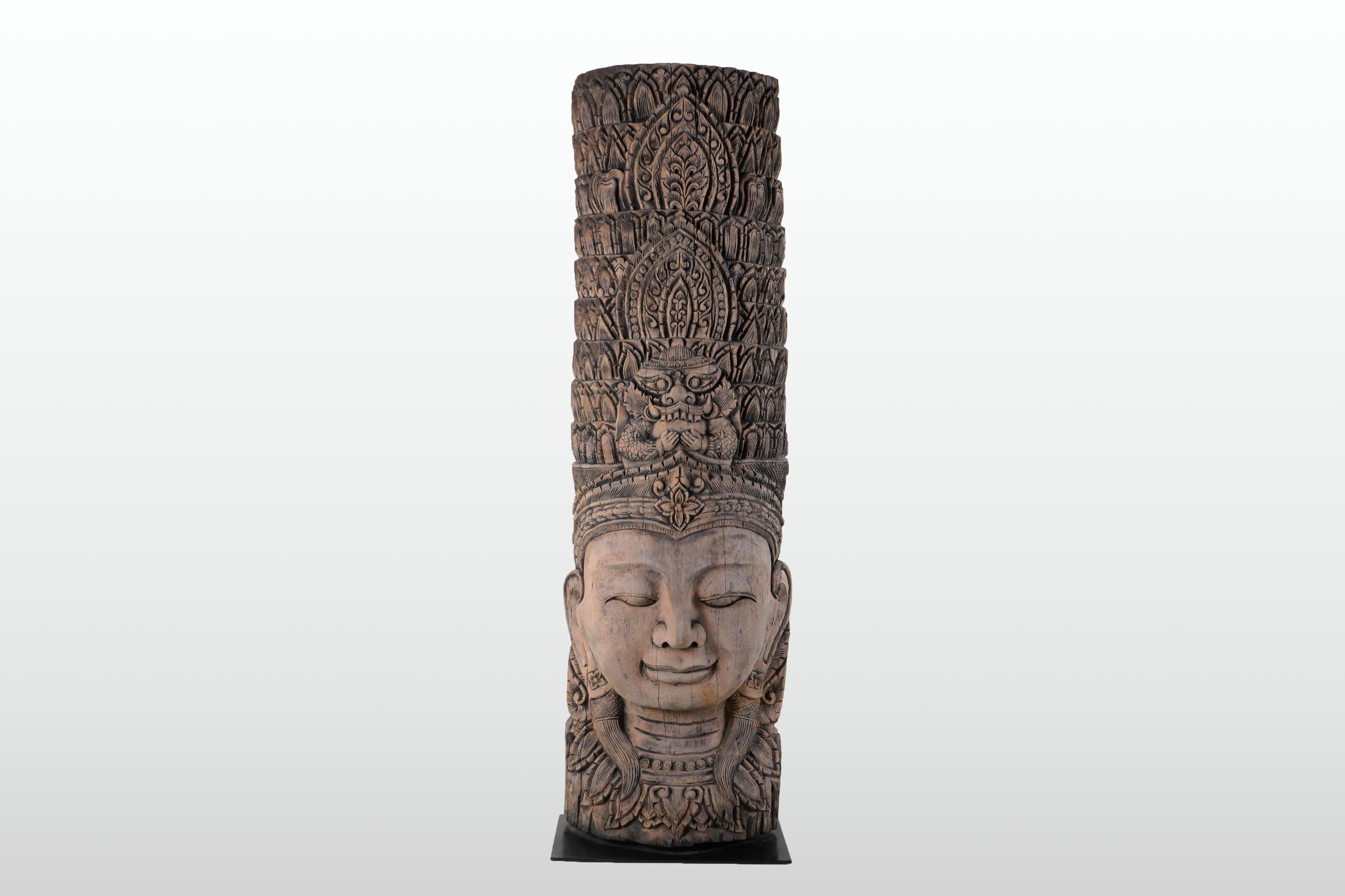 Newly carved from reclaimed teakwood, this bust takes the form of a Cambodian apsara. With origins in Hindu and Buddhist mythology, Apsaras are female spirits of the clouds and waters. They are also referred to as 