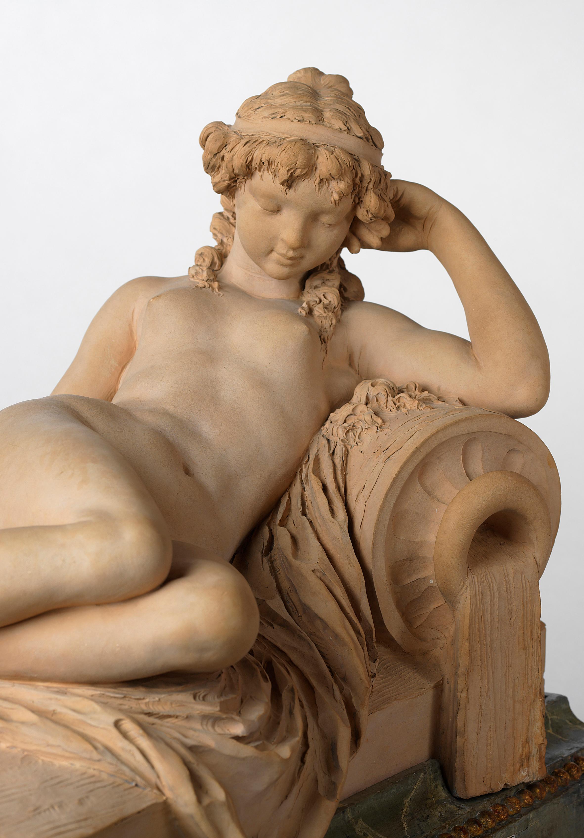 La Source after a marble model by Claude Michel Clodion

The naked figure of a nymph with her head resting on her arm and her eyes closed, is reclining on drapery, and leaning against an overturned urn, which is issuing water. On marbleized wood