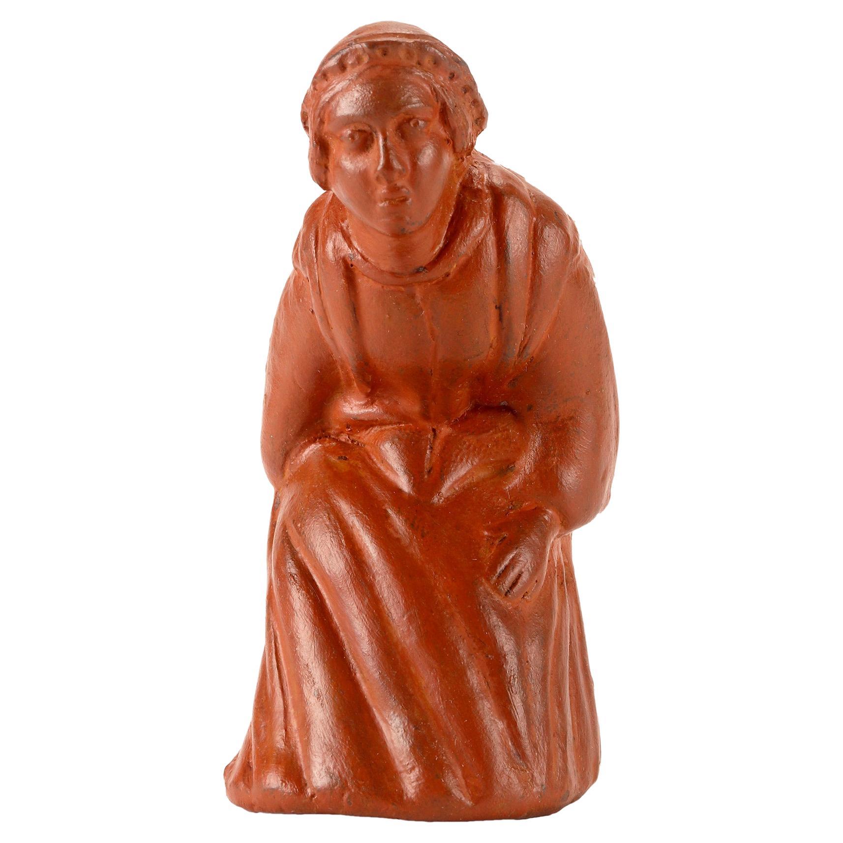 A terracotta snuff box in the form of a squatting woman. France, 1810.