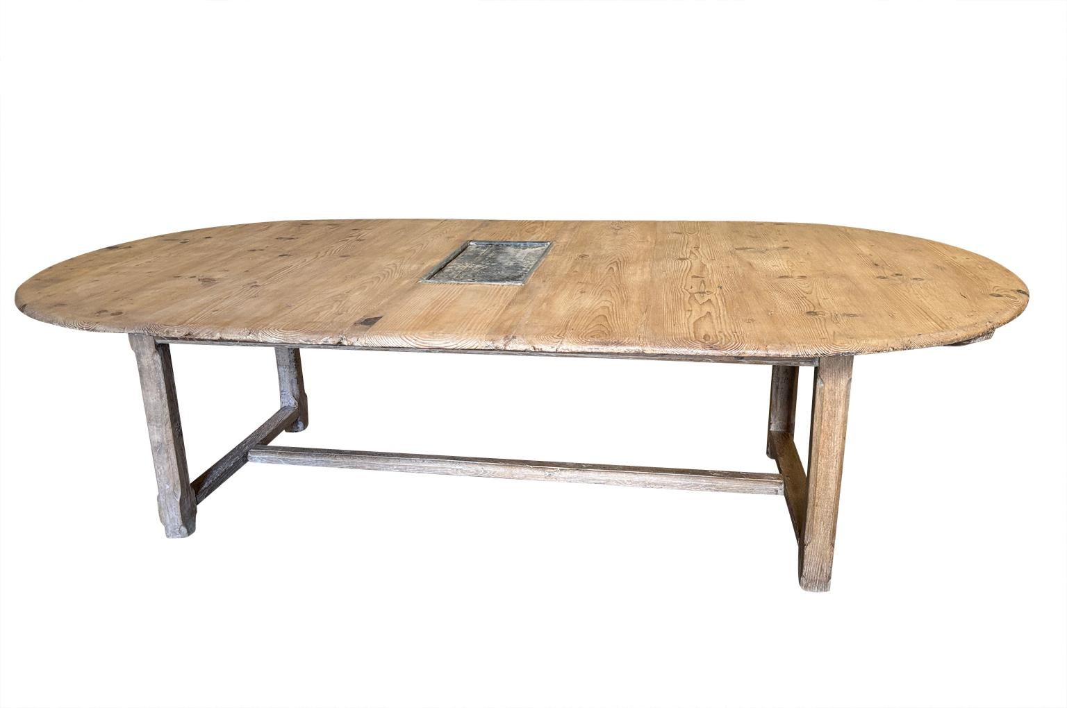 A very charming mid-19th century Table D'Atelier - Farm Table from the Provence region of France.  Wonderfully constructed from sturdy pine with an oval shape and a central zinc plate.  