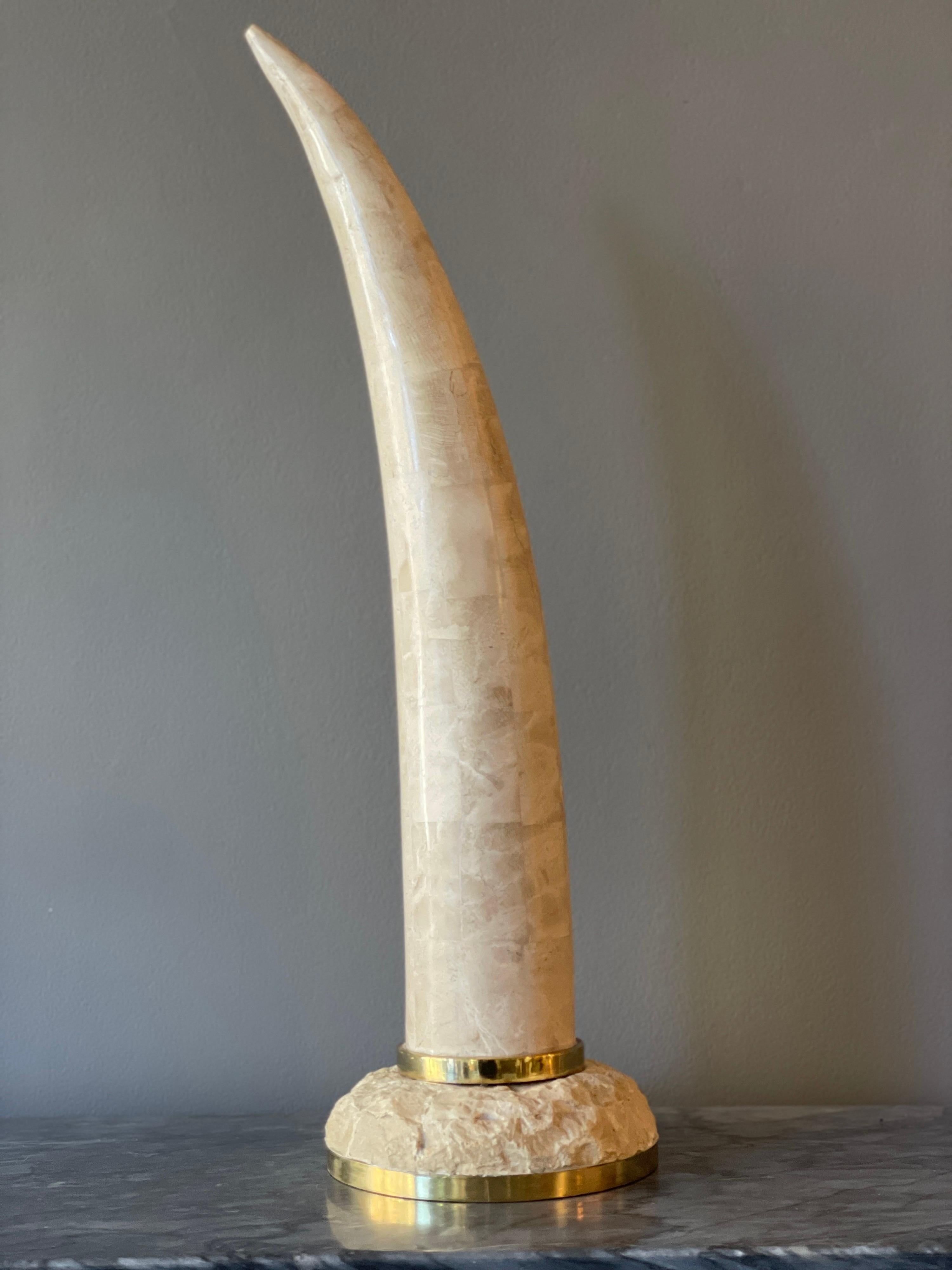 A stylised and large tessellated marble faux Tusk supported on a stone brass banded base. Made by Maitland Smith USA circa, 1980.