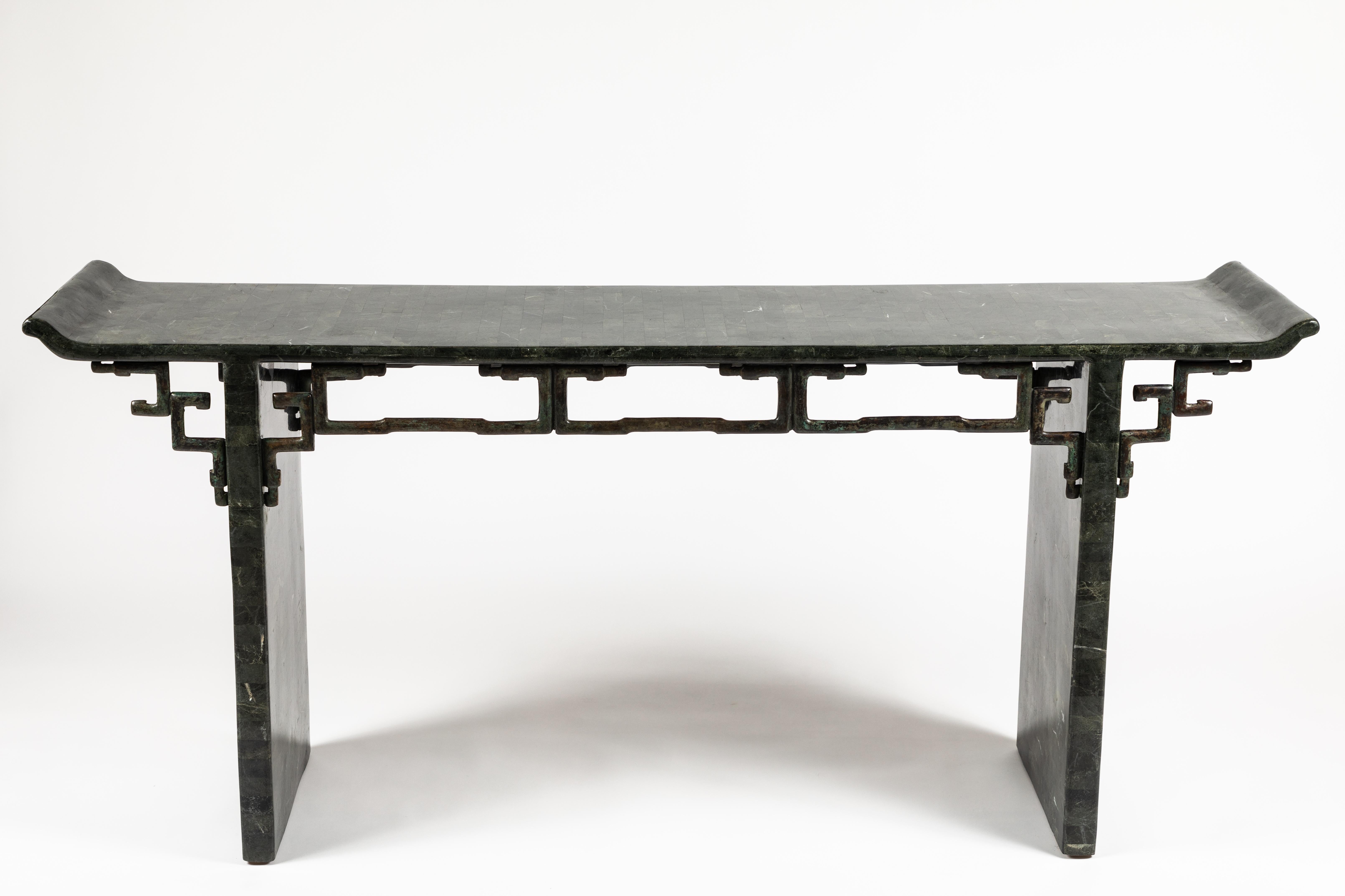 A chic and stylish altar style console table completely veneered in deep green marble. The details to the underside of the top are cast and patinated bronze. Table has style to spare and would work well in both a contemporary or traditional
