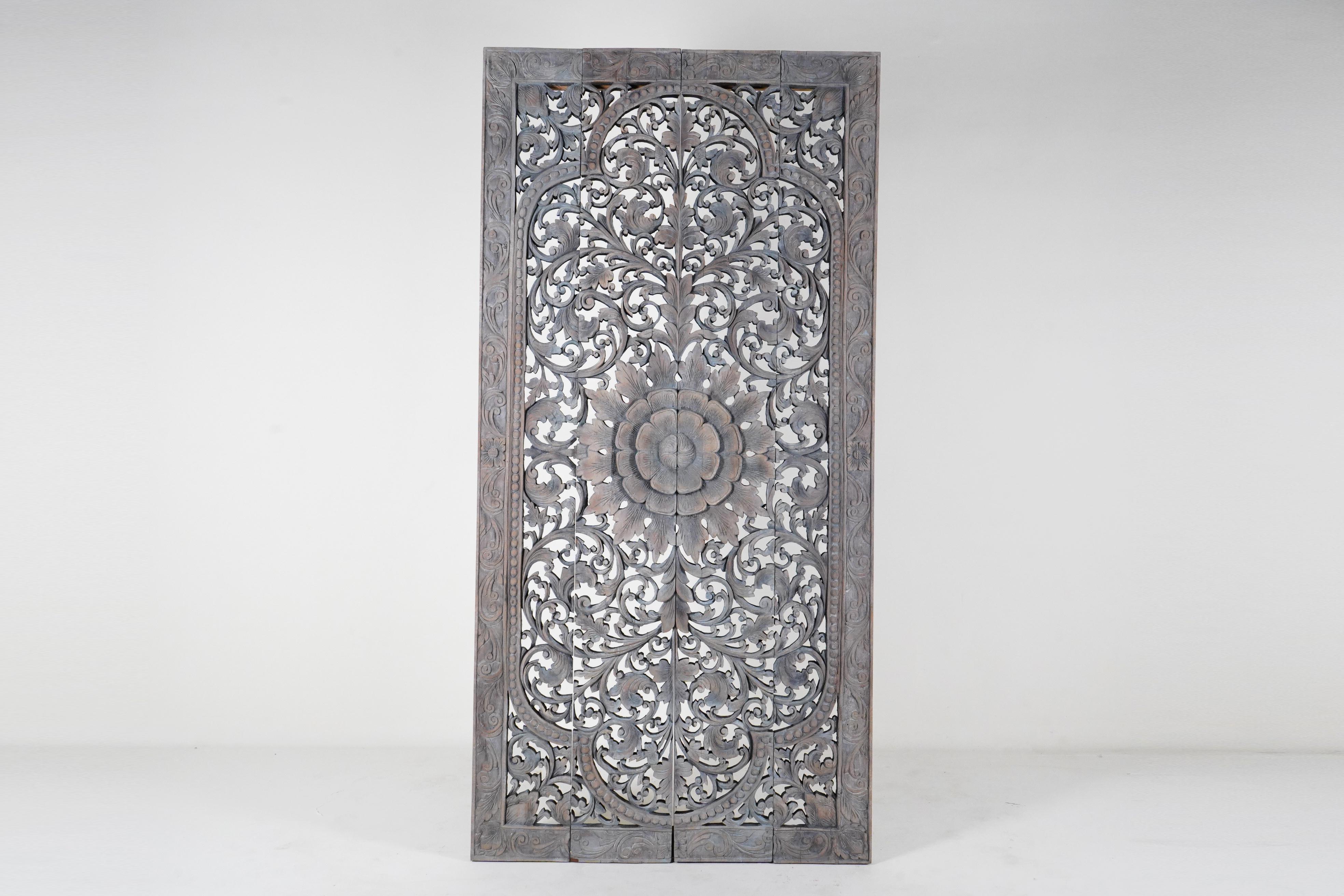 This is a meticulous modern recreation of an antique Thai temple ceiling panel. Northern Thai temples often had intricately carved wooden ceilings made up of coffered panels with carved and gilded lotus flowers in their centers. The overall pattern