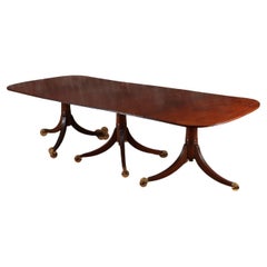 A thirteen foot triple pedestal mahogany dining table with large leaves c. 1940