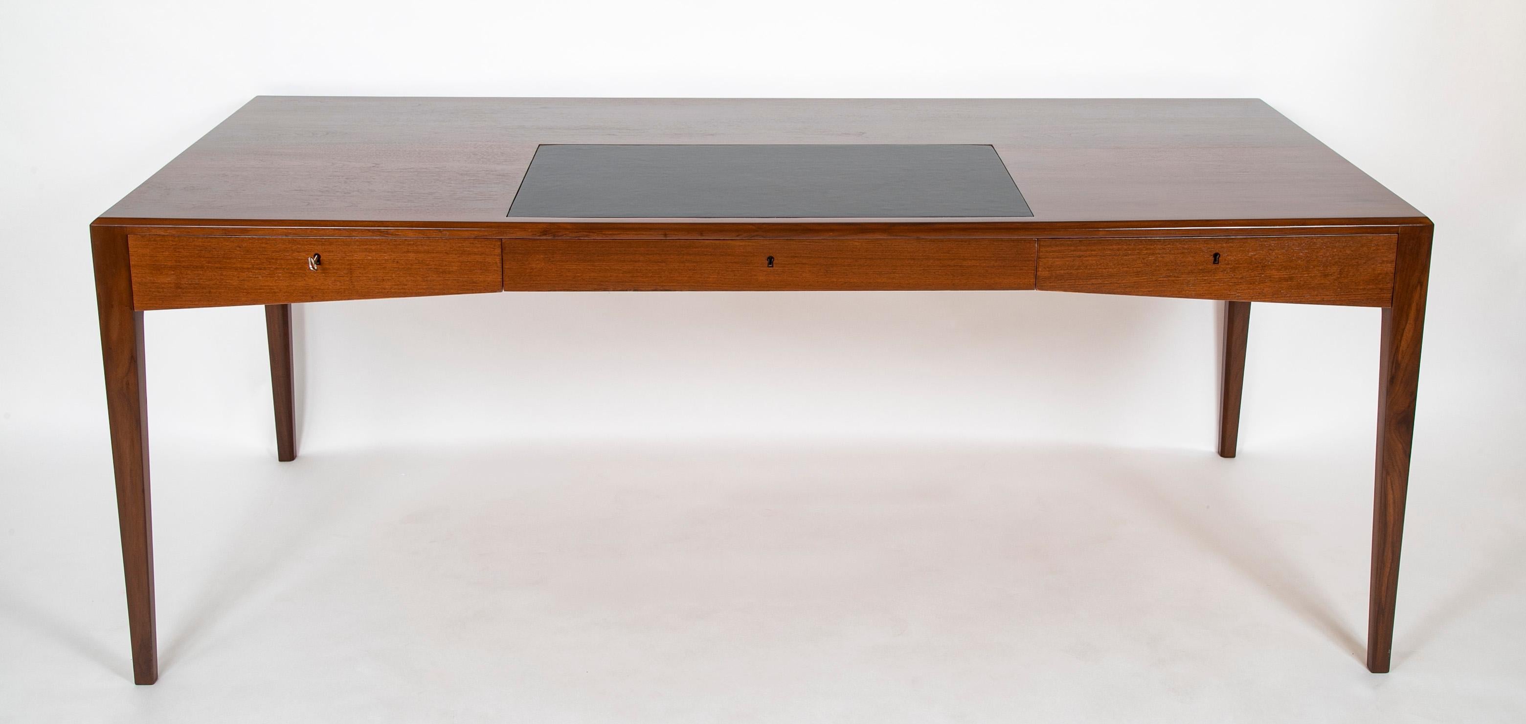 A striking Danish Teak desk designed by Severin Hansen, with great proportions and characteristic seamless joinery. Sleek silhouette.