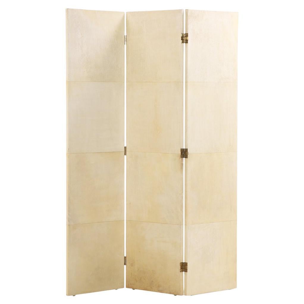A three panel parchment covered folding screen. For Sale