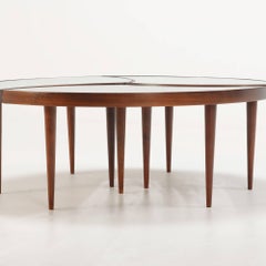 A three-part biomorphic marbleized glass and walnut circular coffee table.