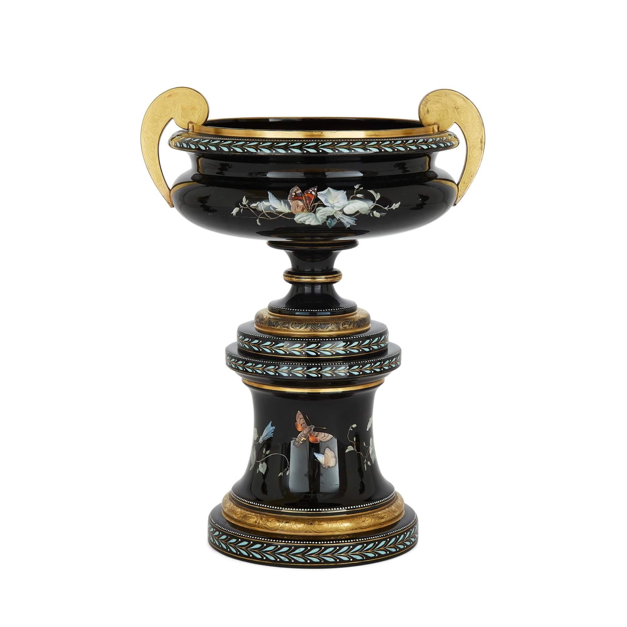 This beautiful three-vase garniture set is made from enamelled black glass, and dates from late nineteenth century Bohemia. Attributed to Gräflich Schaffgotsch'sche Josephinenhütte, in Schreiberhau, Silesia, it is possibly crafted after designs by
