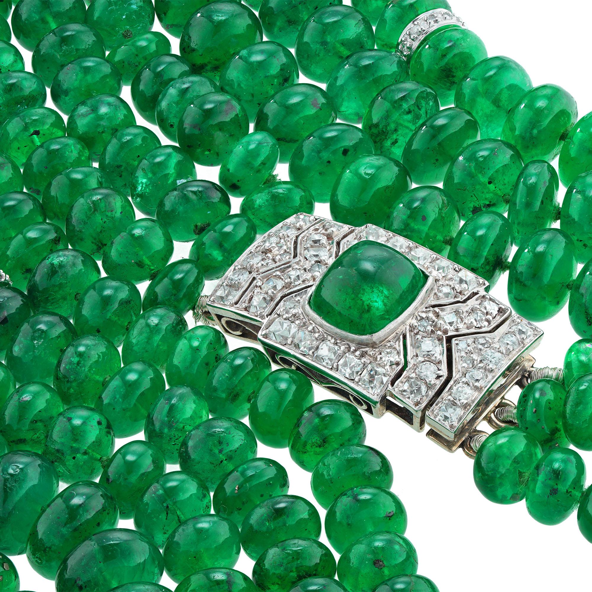 A three-row emerald bead and diamond necklace, the three rows consisting of four-hundred-thirteen button-shaped emerald beads, graduating in size from 10.9mm to 6mm, embellished with twelve diamond-set spacers, all strung from an Art-Deco