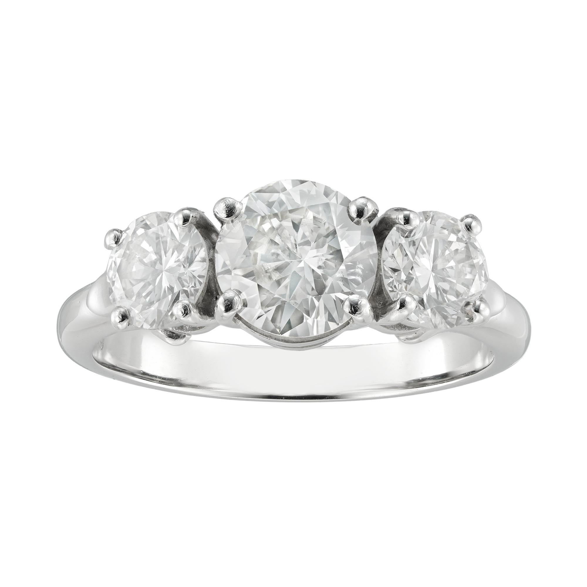 A three-stone diamond ring, the central round brilliant-cut diamond weighing 1.19 carats assessed to be of J colour SI2 clarity, set between two smaller round brilliant-cut diamonds, the one weighing 0.51 and the other 0.57 carats, both assessed to