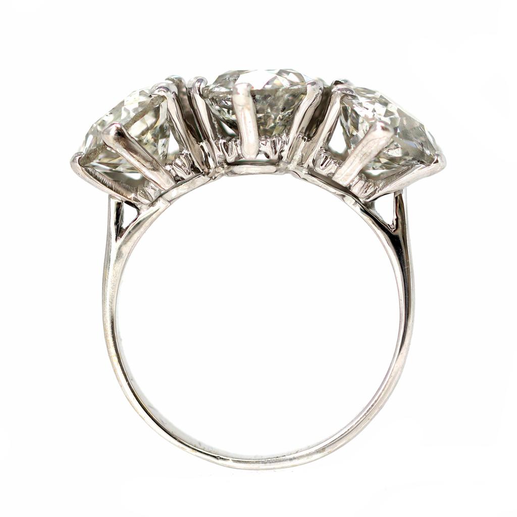 A lavish Three Stone ring featuring 3 Old European cut diamonds with a total weight of 6.42 carats. The diamonds are estimated HI color and SI-I clarity. The handmade mounting was created circa 1950 and set in 18 karat white gold.The gross weight is