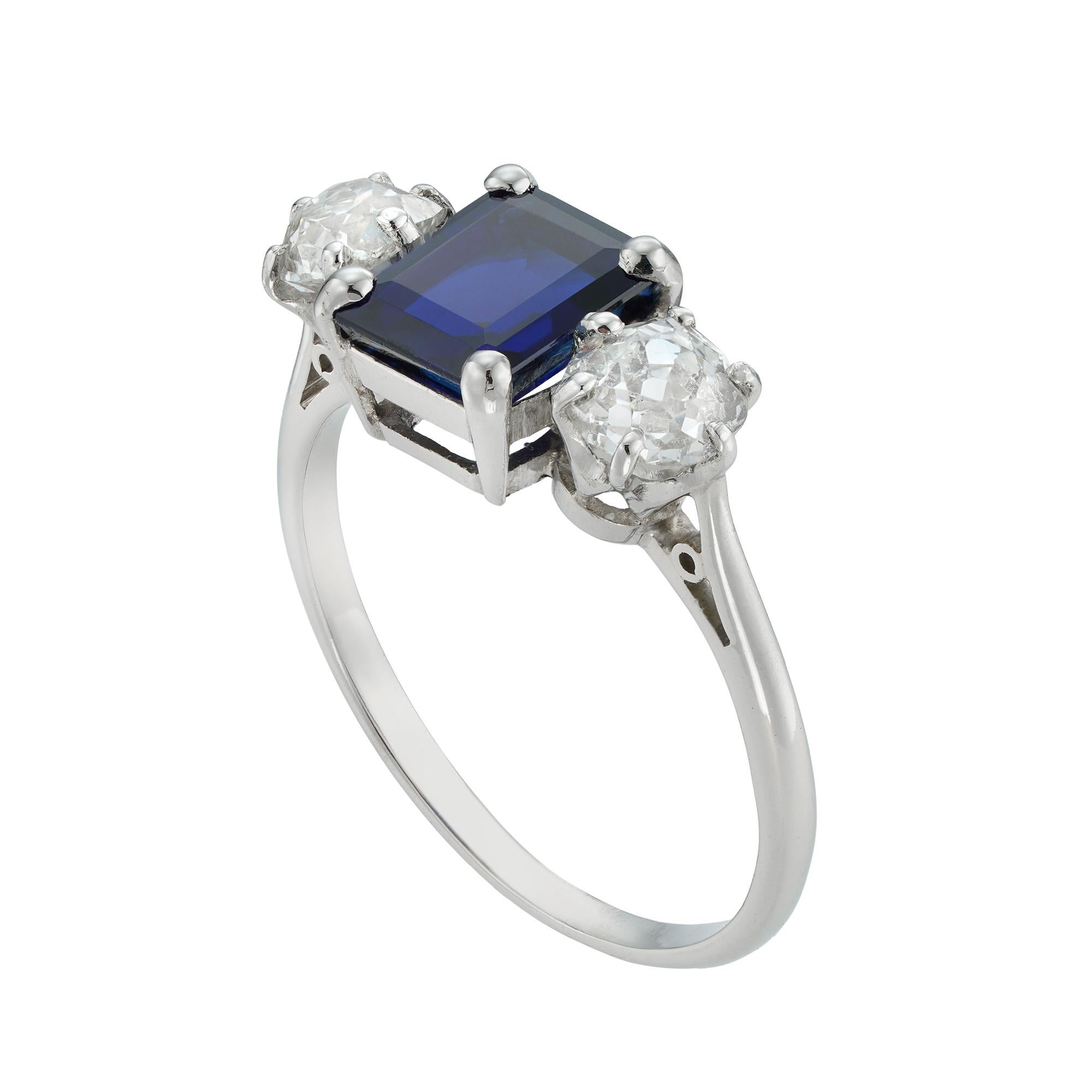 Modern A three stone sapphire and diamond ring
