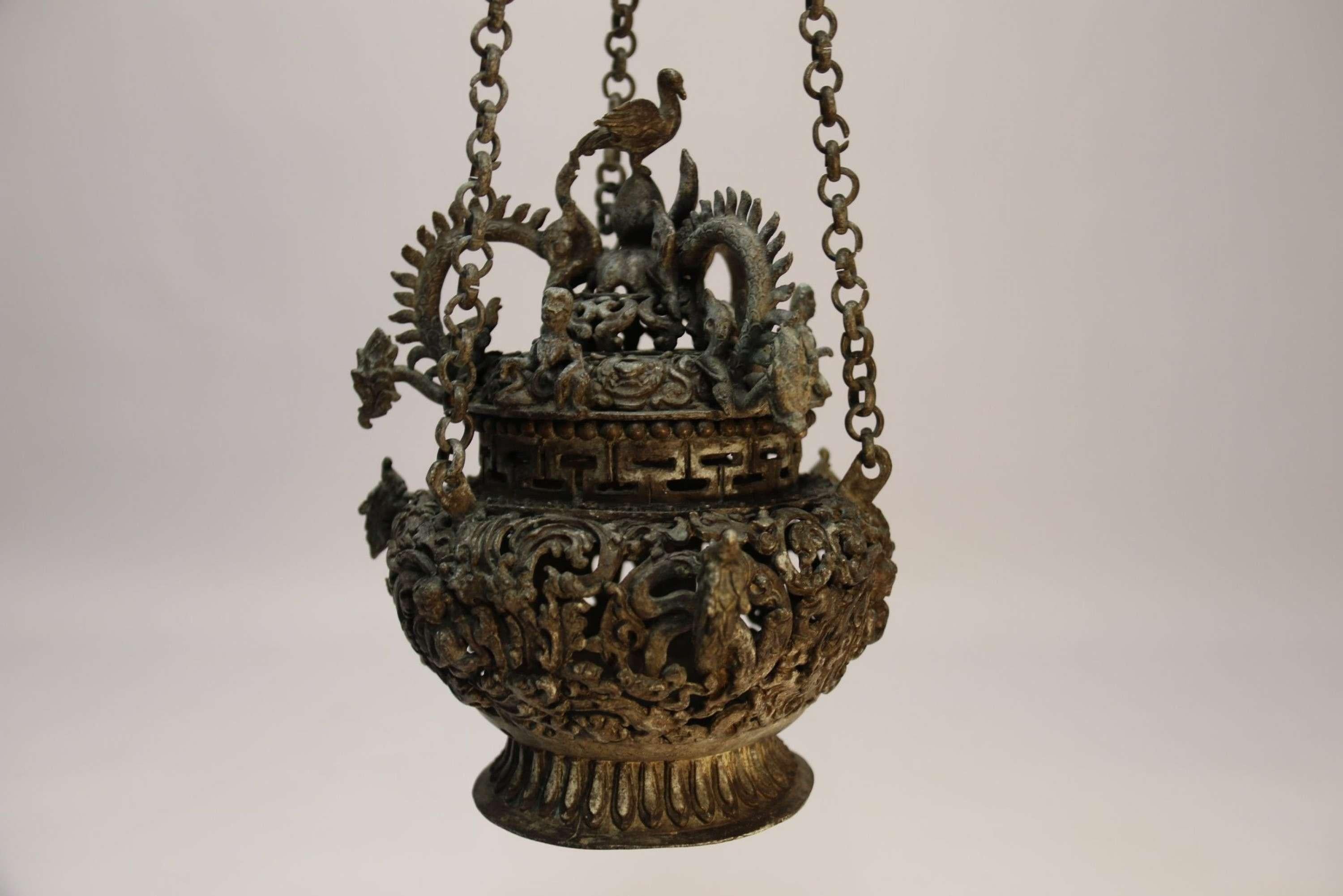 A Tibetan Bronze Incense Burner

This highly decorative piece is made from cast bronze which has a dark patina and Verdigris finish. It is cast with fine detail with figures and mythical beasts amongst a foliate design. It is made in two separate