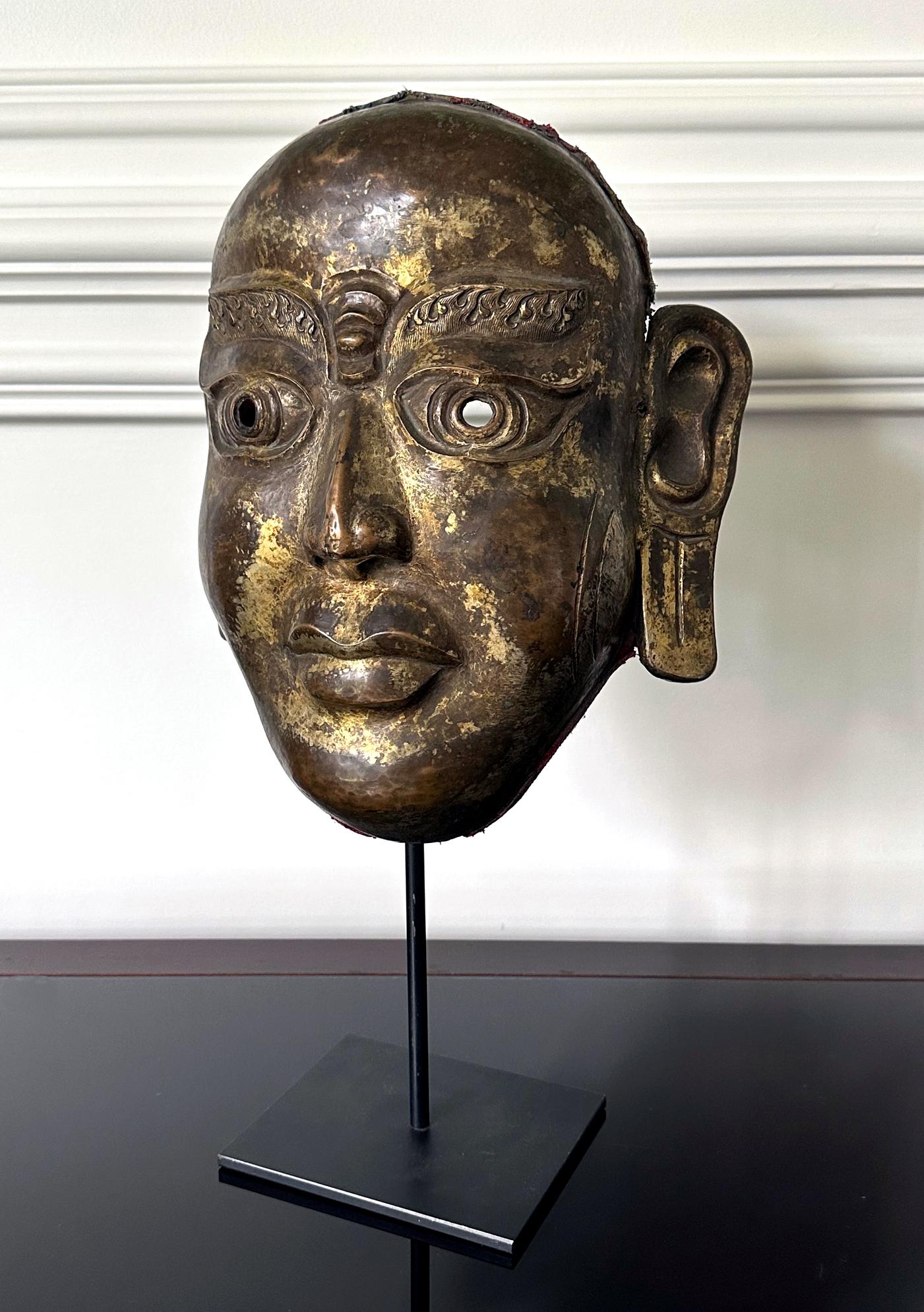Molded Tibetan Gilt Copper Alloy Mask on Display Stand For Sale