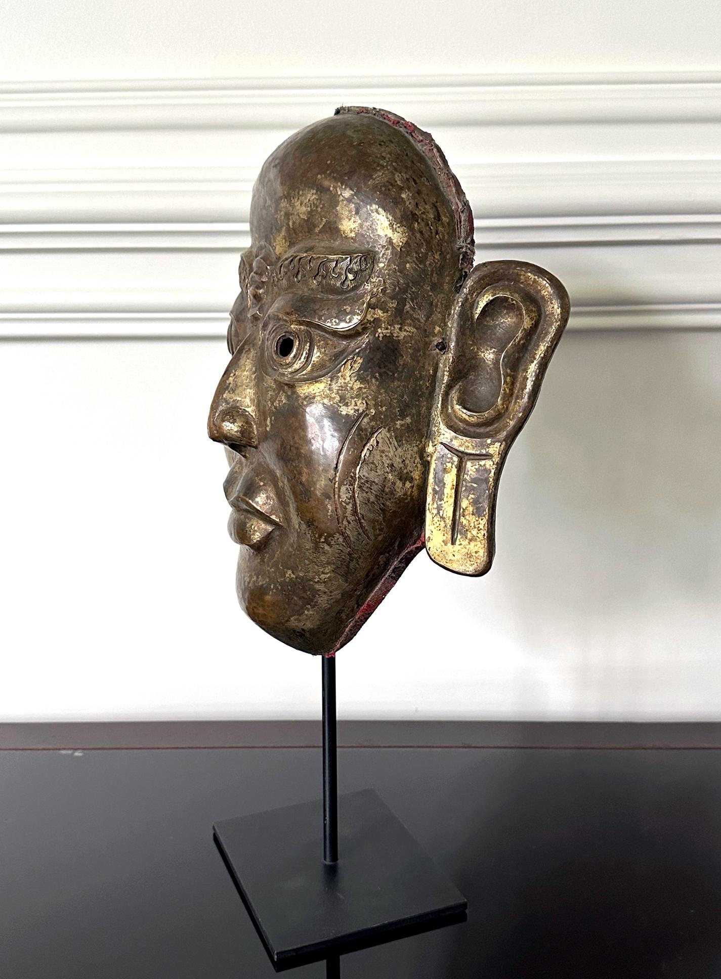 Tibetan Gilt Copper Alloy Mask on Display Stand In Good Condition For Sale In Atlanta, GA