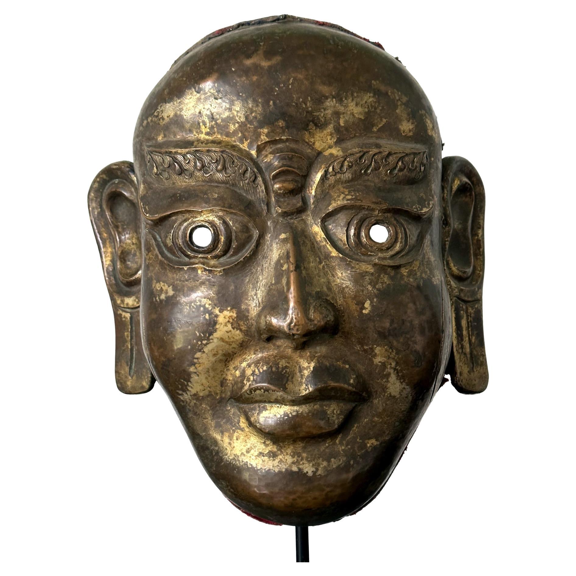 Tibetan Gilt Copper Alloy Mask on Display Stand For Sale