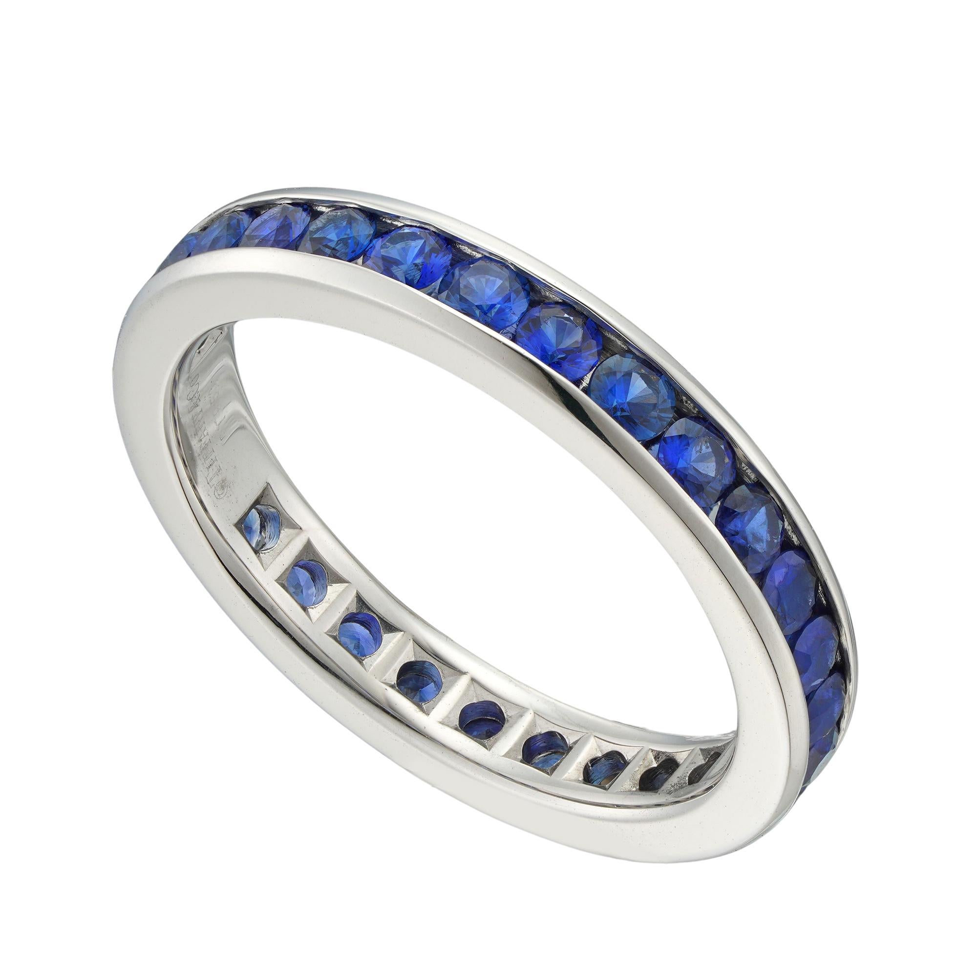 A Tiffany & Co sapphire full eternity ring, set with 28 round faceted sapphires estimated to weigh 1.25 carat all channel-set in platinum mount, marked Tiffany & Co, later hallmarked 950 platinum London, measuring 2.1 x 0.3cm, finger size L, gross