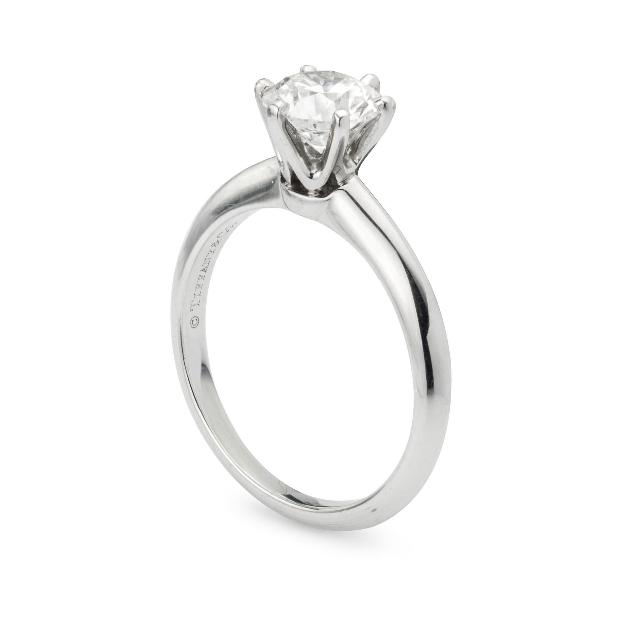 A Tiffany& Co.  single stone diamond ring, the round brilliant-cut diamond weighing 1.04 carats, of F colour and IF clarity, accompanied by a GIA certificate , six claw-set to a platinum mount with knife edge shoulders, engraved 'Tiffany & Co.',
