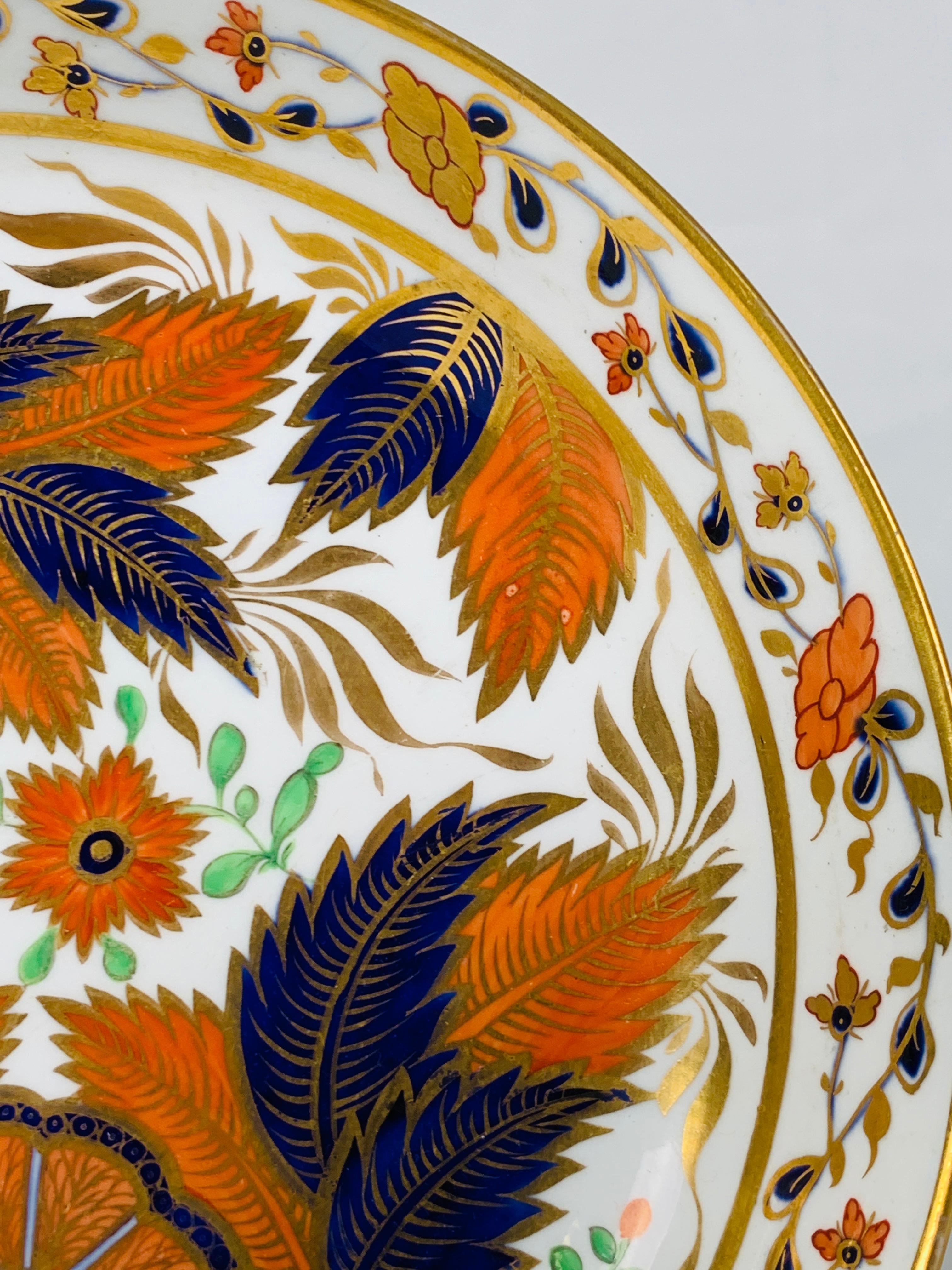 We are proud to offer this exquisite hand painted tobacco leaf pattern saucer dish. Made in England during the Regency period, circa 1820. This saucer dish closely copies an original Chinese 18th century design. Of all the 18th century porcelain