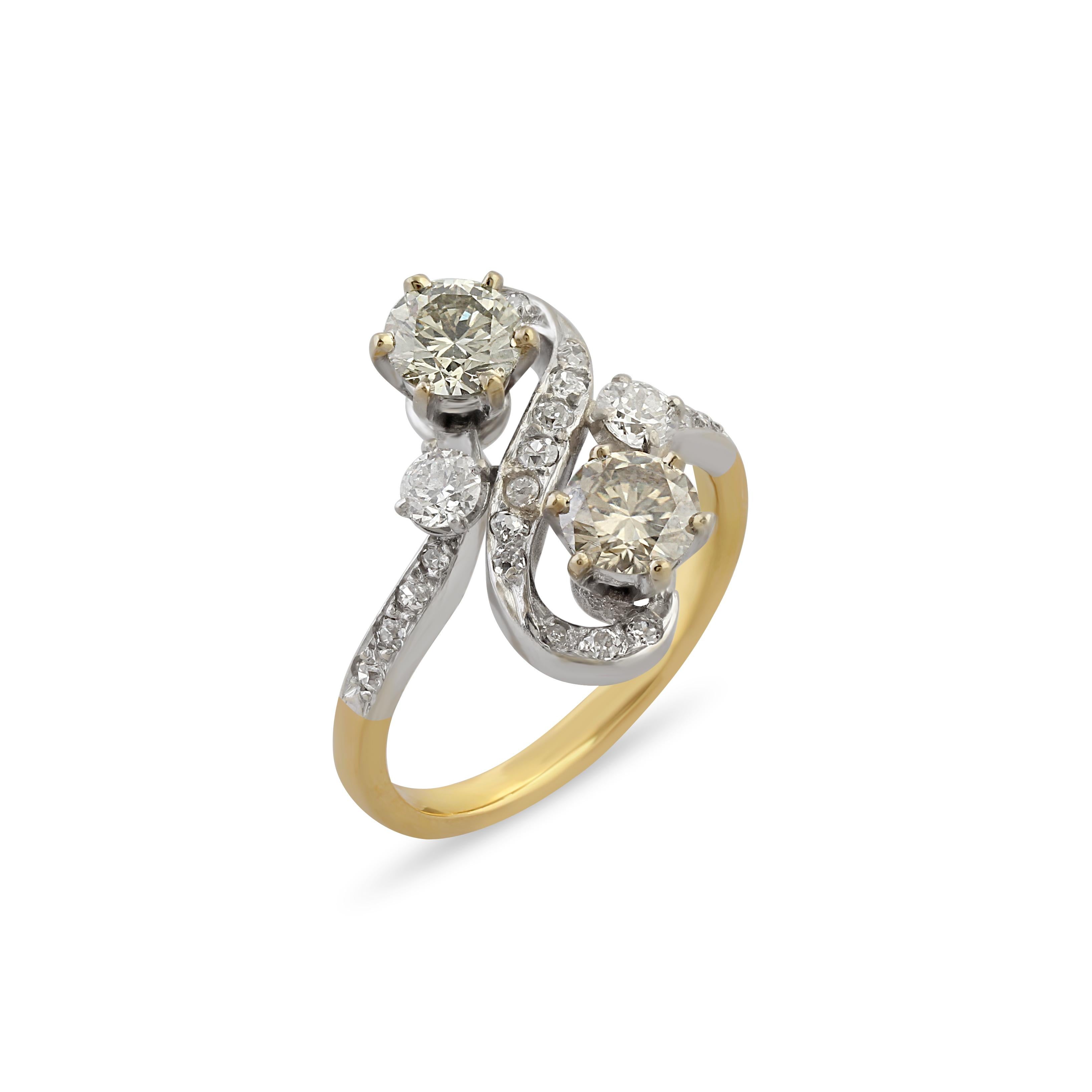 A platinum on gold toi et moi engagement ring, set with two old-cut diamonds of approximately 0.52 carats each surrounded by an additional 0.25 carats of diamonds. Circa 1900.