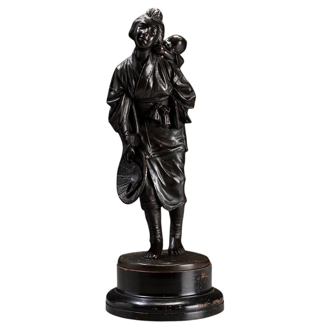 A Tokyo school bronze okimono depicting a young mother with child