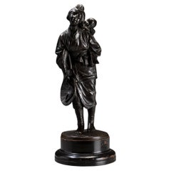 A Tokyo school bronze okimono depicting a young mother with child