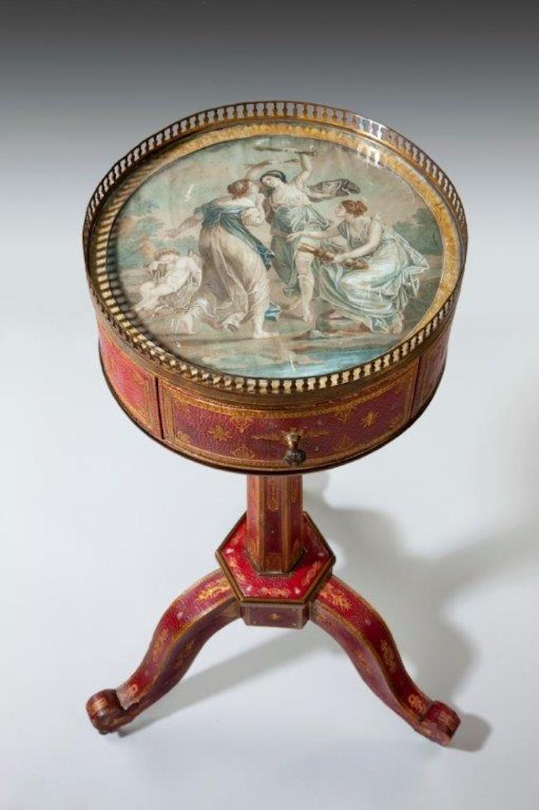 This rare Charles X table has a small round top with an aquatint inset under glass within an ormolu gallery. The engraving shows the Three Graces stealing arrows from Cupid as he sleeps curled up against a rock. The table itself comprises a frieze