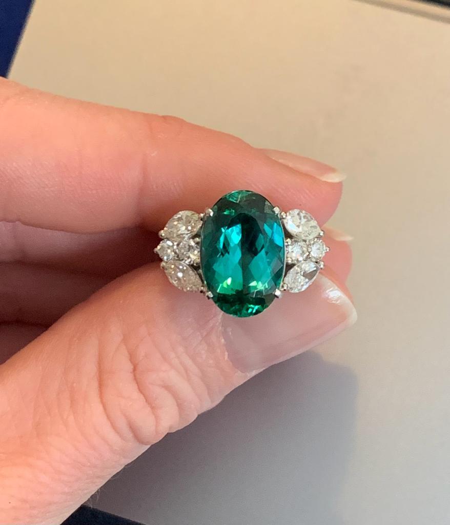 A dark green indigolite tourmaline set with diamonds in platinum. size 53. Tourmaline weighs 6.38 ct and the diamonds approximately 1.72 ct total. Estimated diamond quality H-I, SI. 