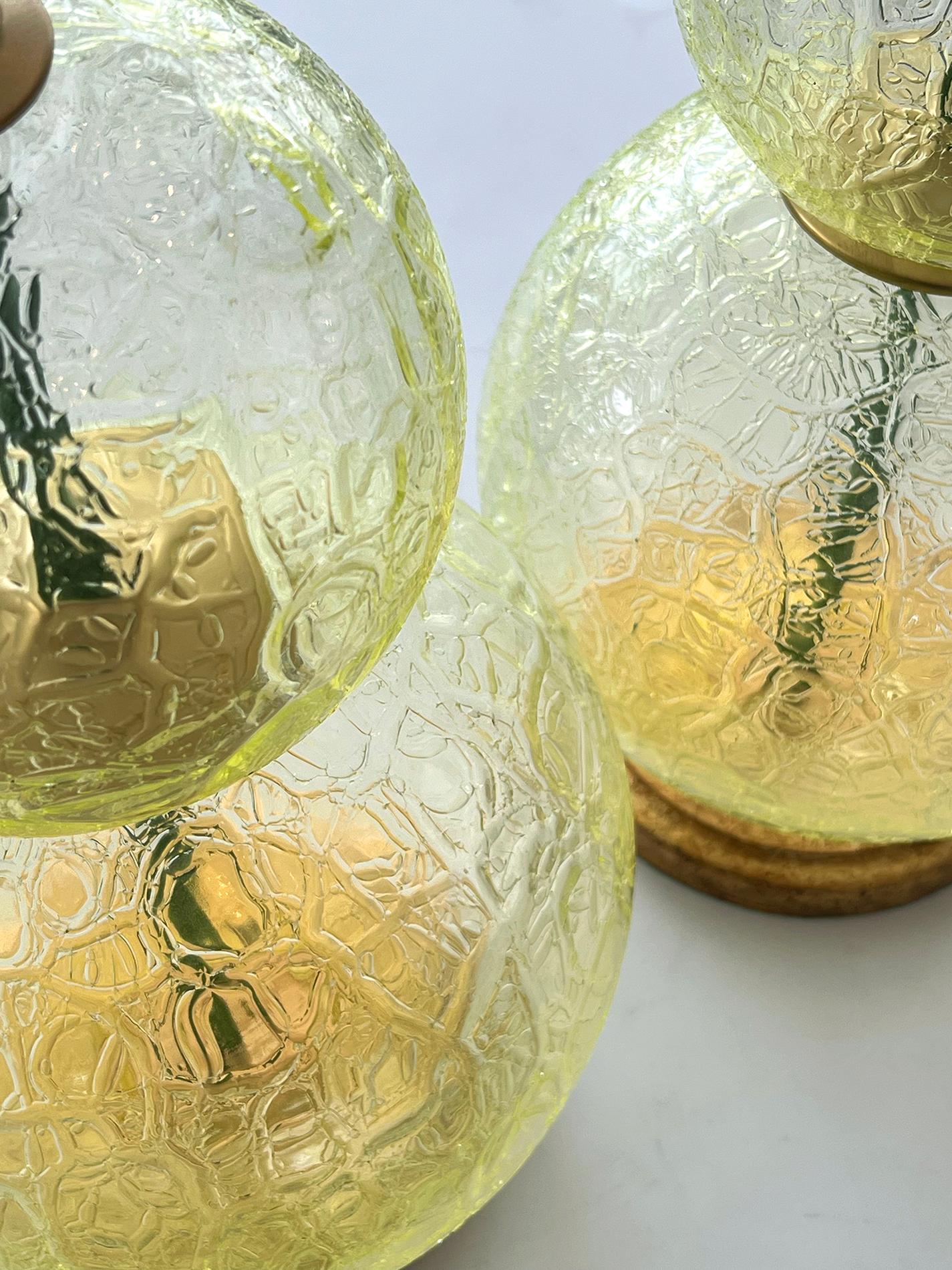 each lamp by Swank Lighting in a magical textured chartreuse-colored glass with a frost-like translucent finish creating a blurry surface allowing scattered light to pass through; each with foil 'Swank Lighting' label; raised on giltwood bases