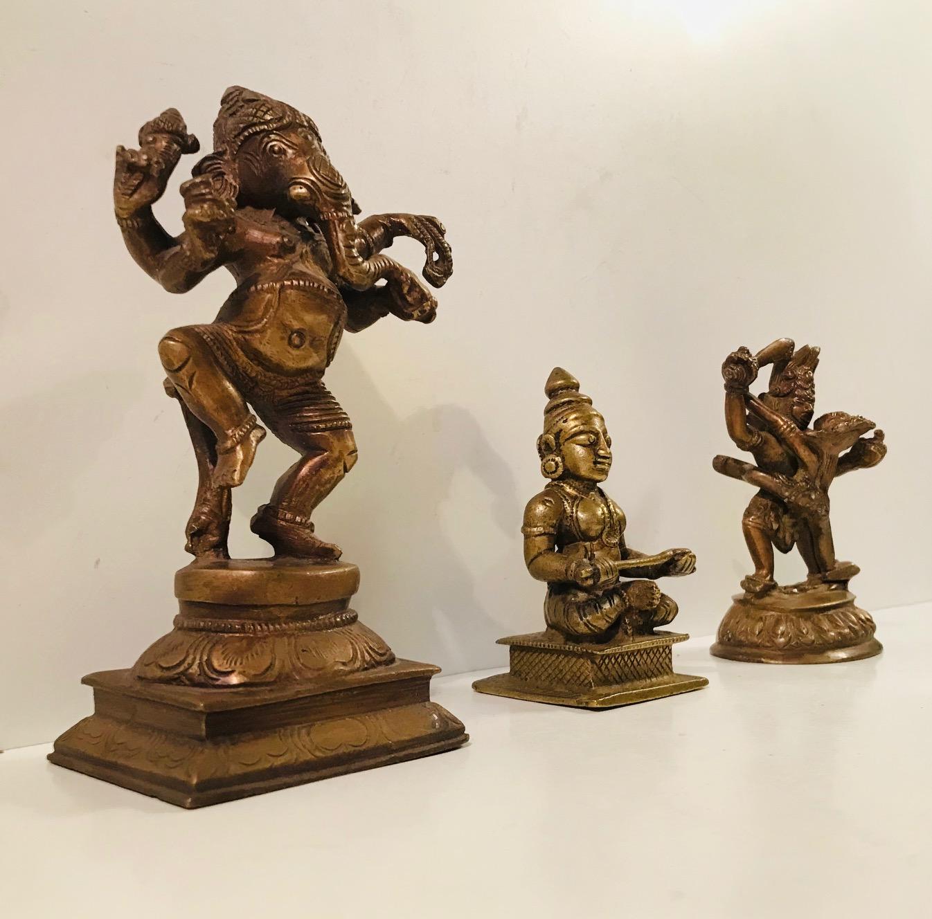 A set of 3 mythological figurines depicting Hindu Gods. All of them are at least 100 years old and made from cast bronze. The detailing is executed by hand and are uneven in places. The price is for the lot.