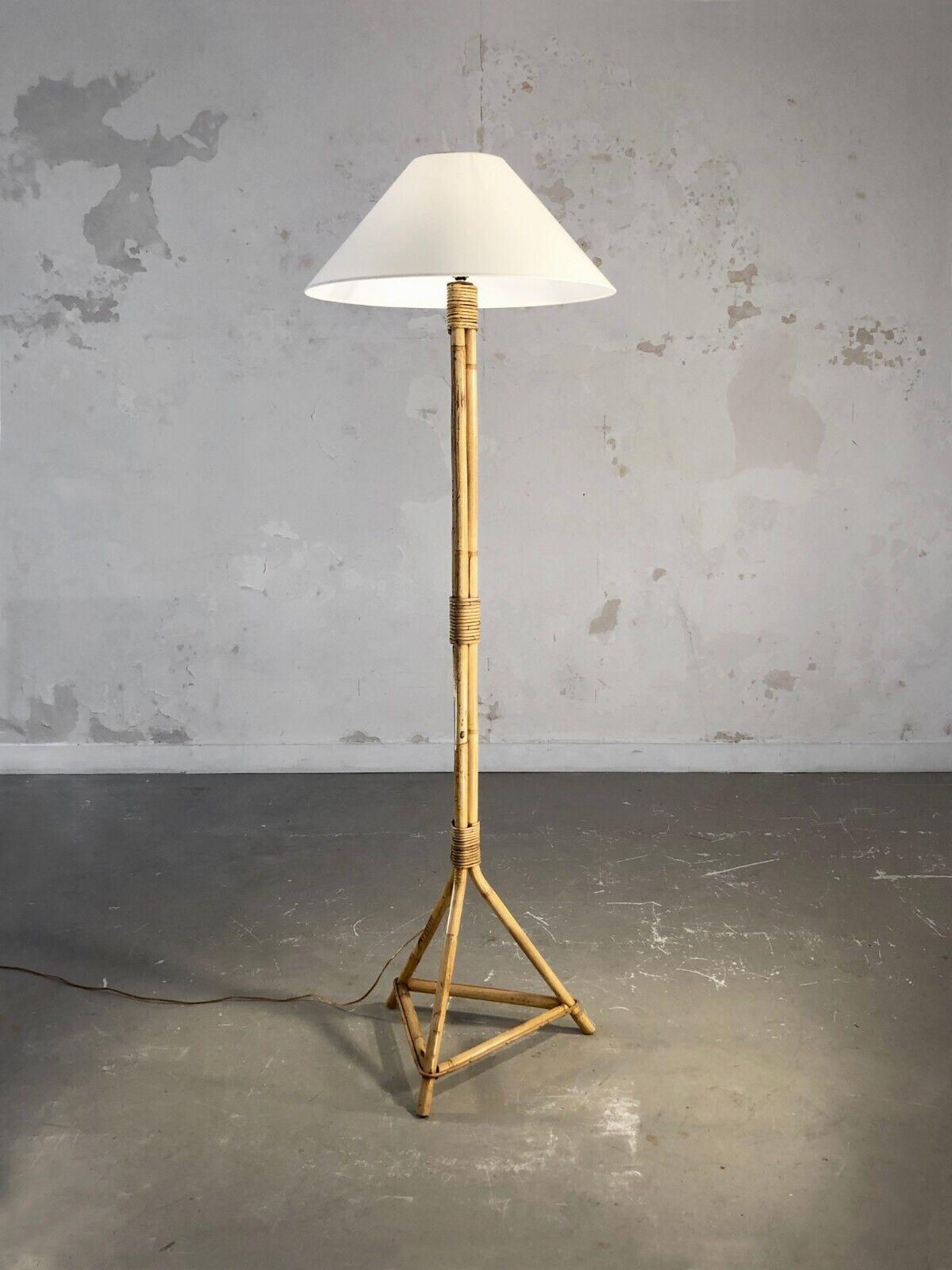 A very simple, minimal and rigorous tripod floor lamp, Modernist, Rustic-Modern, Art-Popular, Brutalist, pyramidal structure base in bamboo, vertical axis in 3 knotted bamboo tubes, supporting a beautiful traditional off-white lampshade, to be