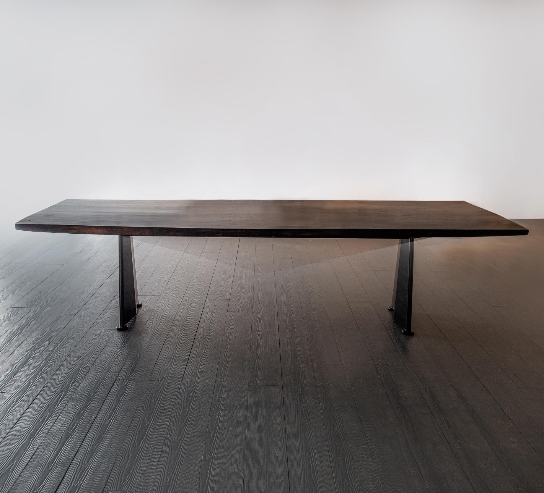 Rare longer version of the coveted and iconic ‘Trapeze’ by Jean Prouvé with sensational solid slab sculptural tropical hardwood top. Featuring the longer discontinued pressed and welded steel base section with crossbeam no longer in production,