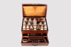 A trunk style travel apotecary cabinet in mahogany wood and brass, England 1790.