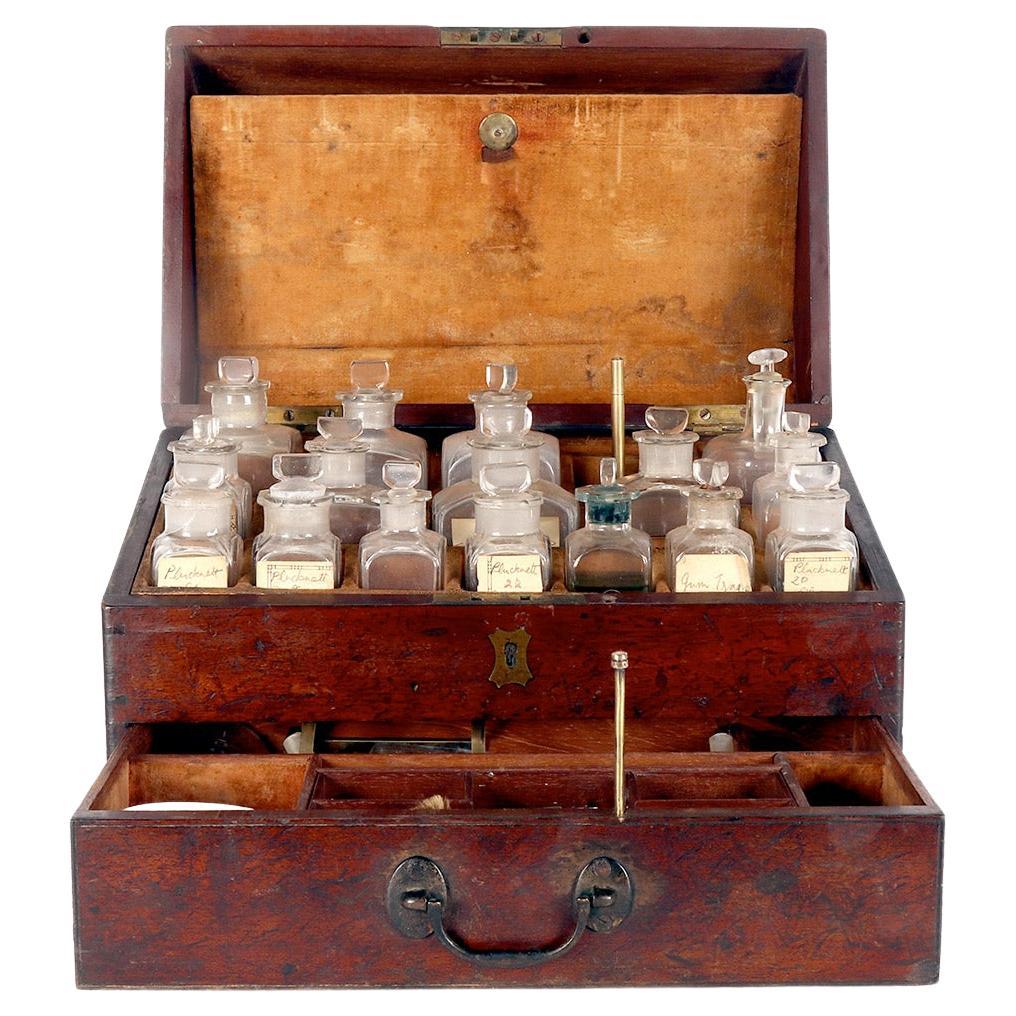 A trunk style travel apotecary cabinet in mahogany wood and brass, England 1790.