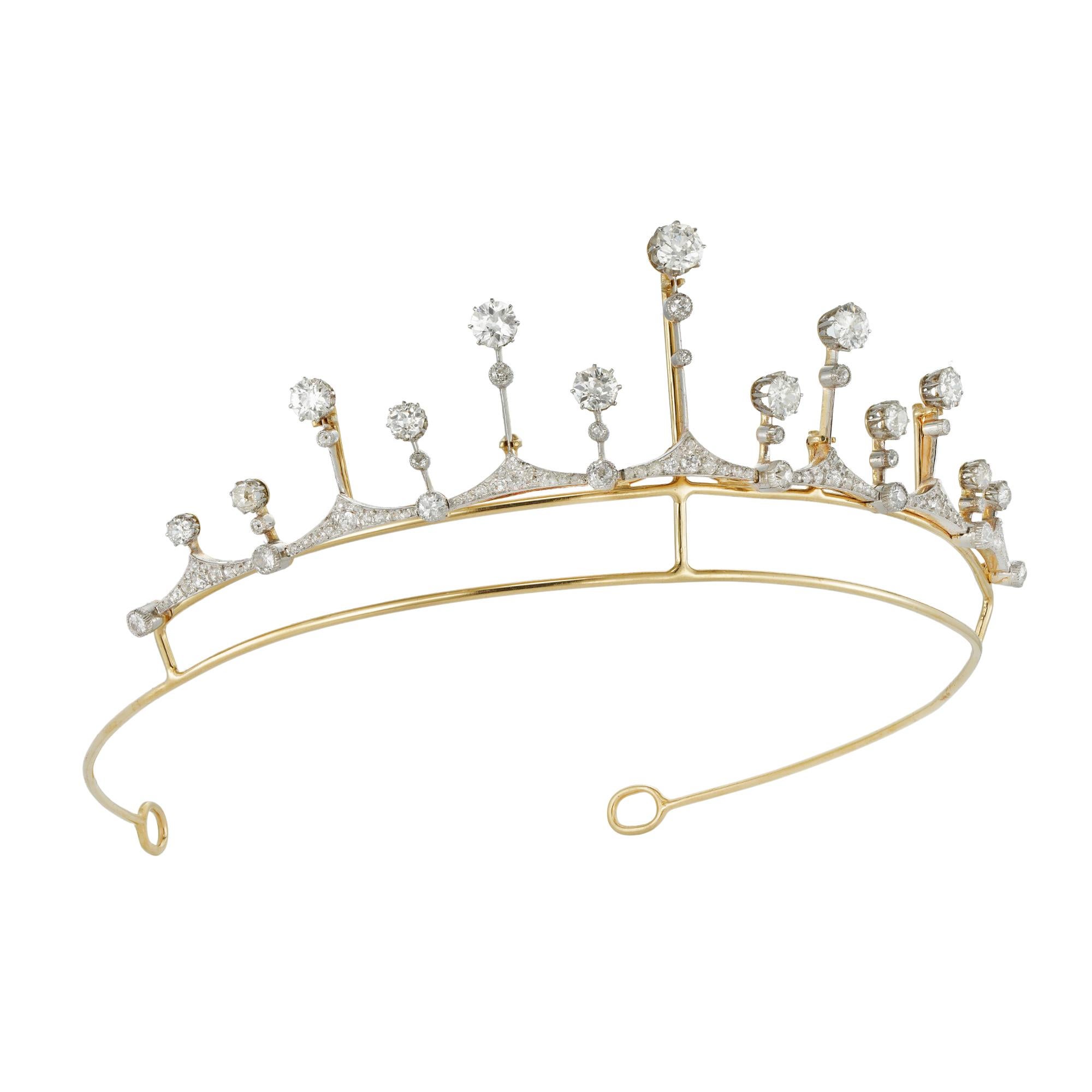 A turn of 20th century diamond fringe tiara/necklace, graduating from the centre formed by thirteen knife-edge bars, the central bar set at the top with an old cut-diamond estimated to weigh 0.85 carats, each bar terminating to an old-cut diamond