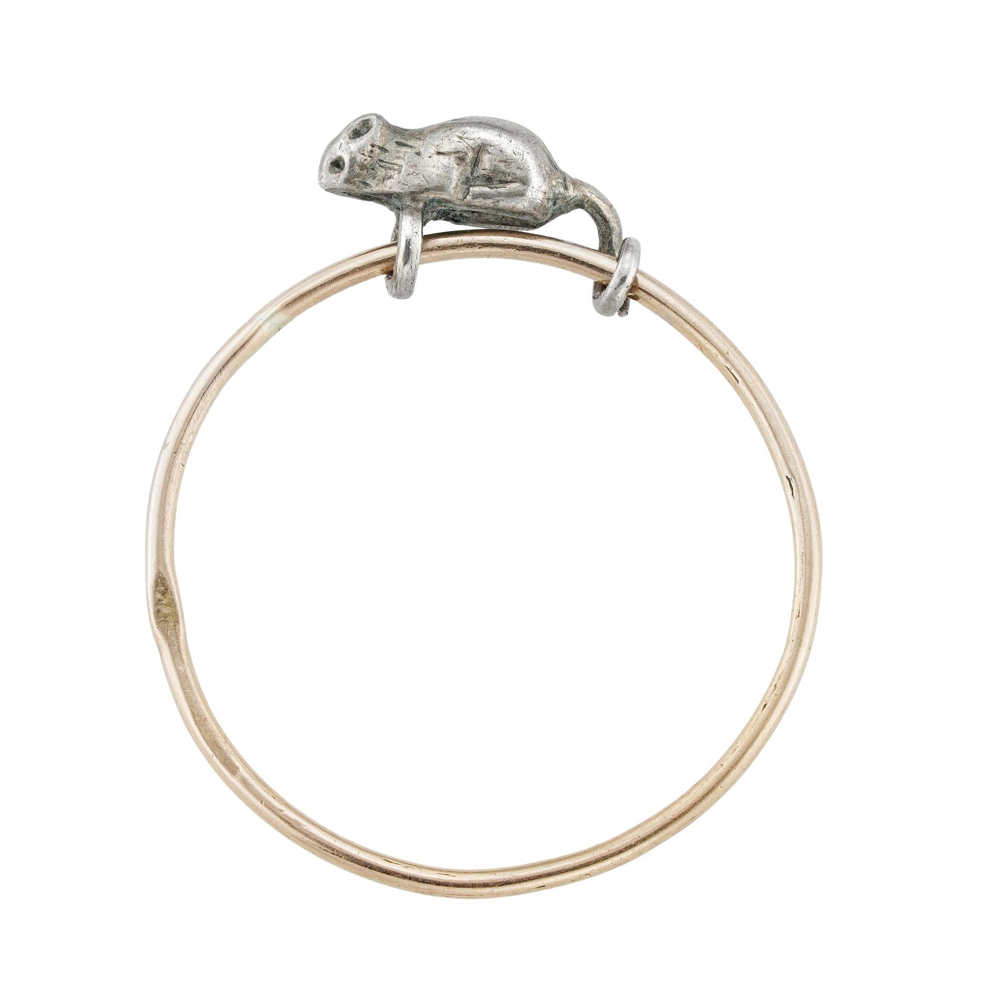 A Turn-of-the-20th-century Russian mouse ring, the realistically carved silver mouse having its tail and its front feet wrapped around a rose-gold ring, the ring measuring 0.8mm wide, bearing Russian workmaster’s mark possibly for Tchelkanov Dmitry