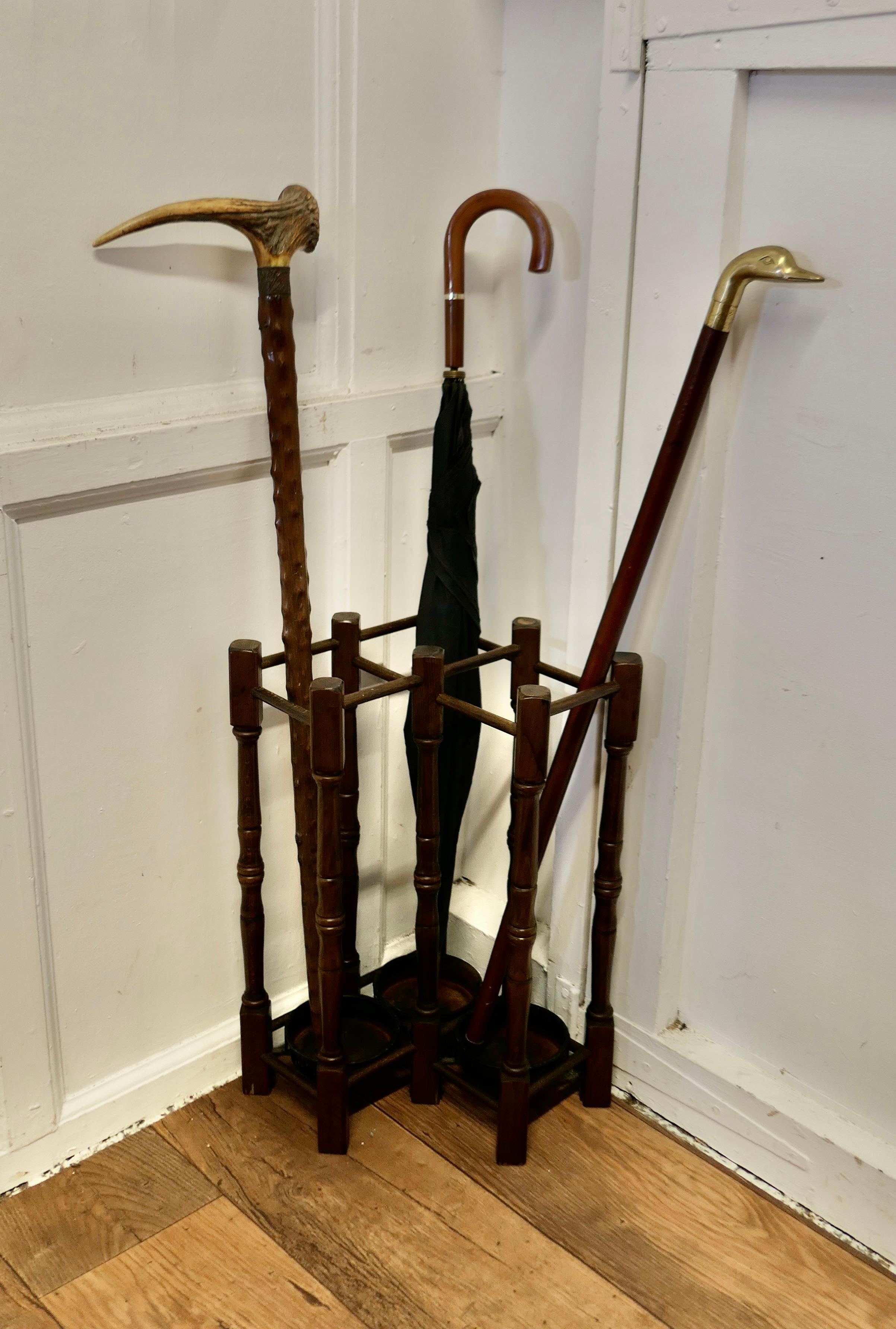 A Turned Beech Corner Stick and Umbrella Stand

This is a very unusual piece, it is made from dark turned beech spindles and it fits very neatly into a corner, it has 3 large sections with a removable drip tray at the bottom each
The stand is 21”