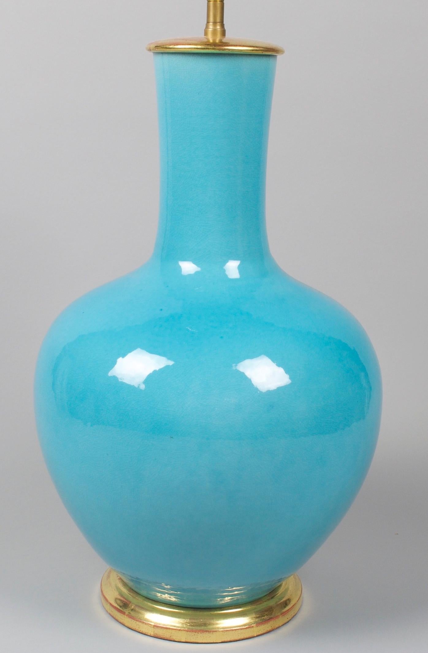 Superb turquoise blue straight necked porcelain vase, now mounted as a table lamp, with a hand-gilded turned base.

Height of vase: 17 1/2 in (44.5 cm) including the base, but excluding any electrical fitment and lampshade.

All of our lamps can