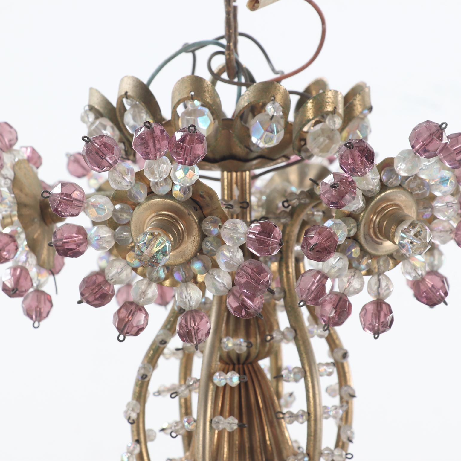 Brass A twelve arm brass and glass beaded chandelier with amethyst beads circa 1950. For Sale