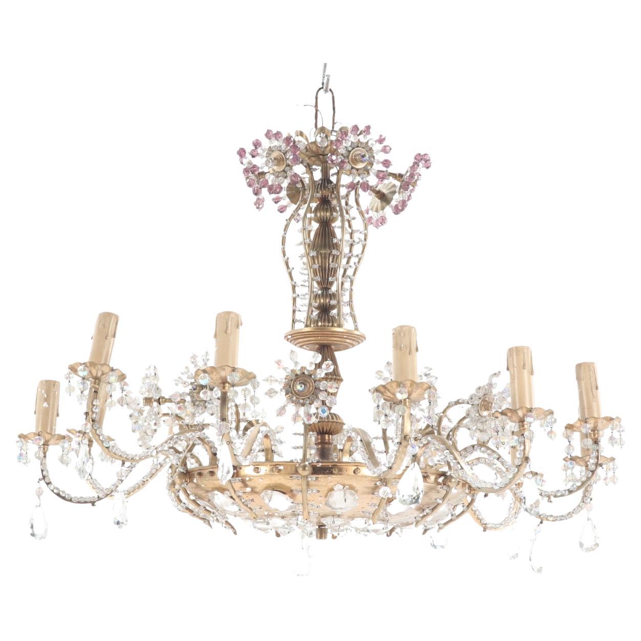 A twelve arm brass and glass beaded chandelier with amethyst beads circa 1950.