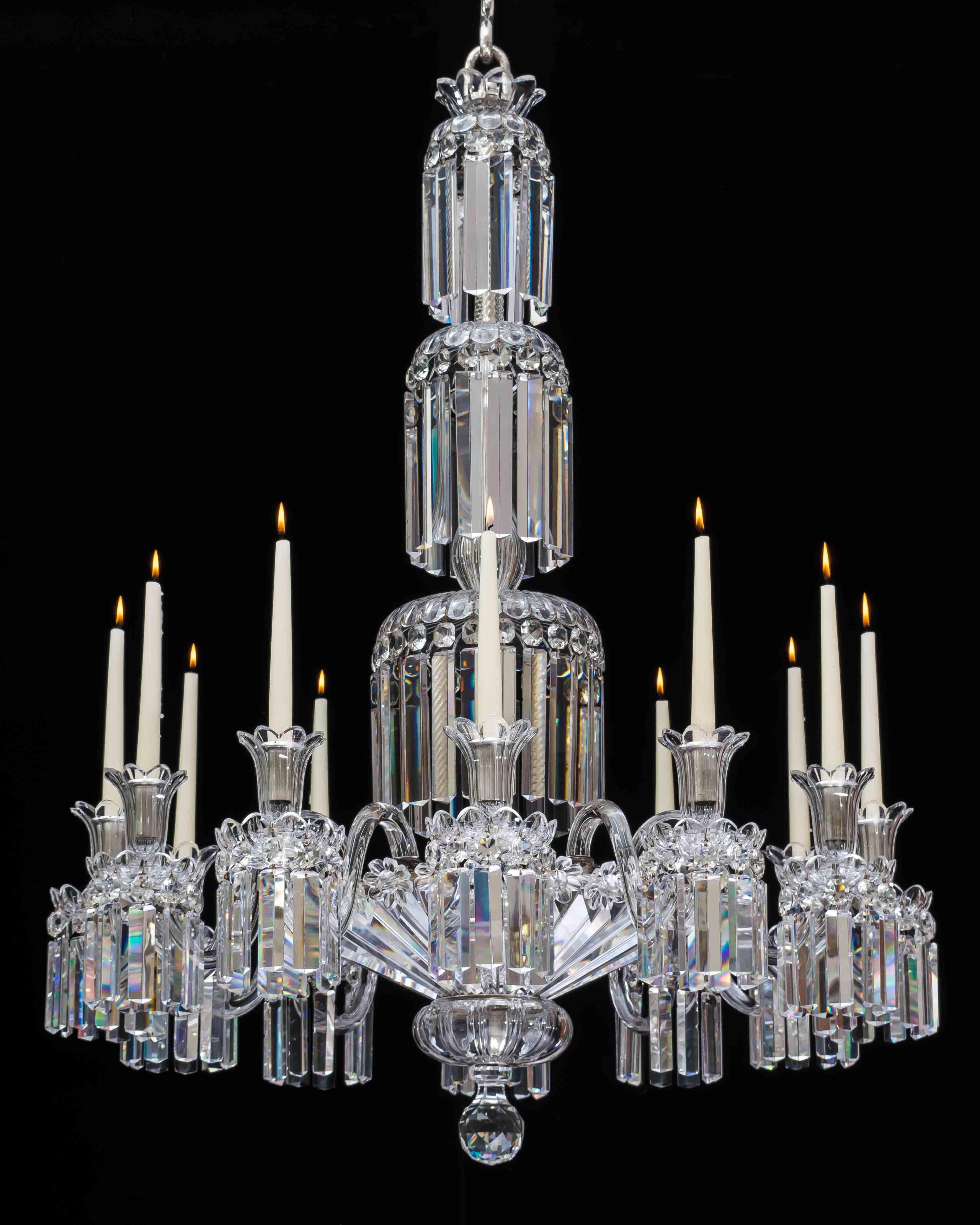 A fine quality William IV silver mounted chandelier the stem with graduated drop hung dishes cascading down to the main frame, issuing twelve plain arms supporting drop hung scalloped edge drip pans and candle nozzles, the frame incased underneath