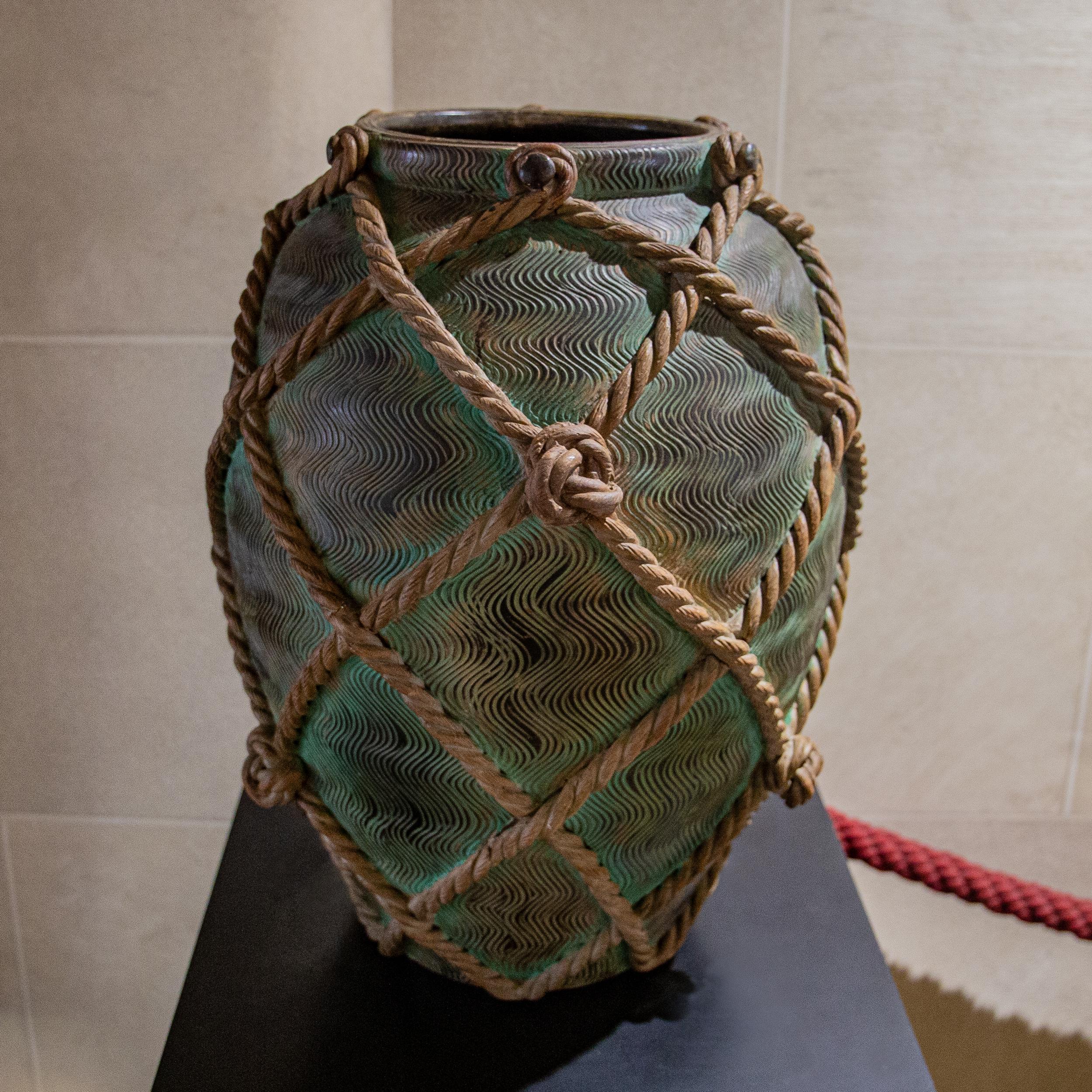 A work of art by the early 20th century by master sculptor Ugo Zaccagnini. Of generous scale, with verdigris bronze Roman strigil relief patterned body and simulated twisted and knotted rope design. Incredible ceramic work and detail, the rope